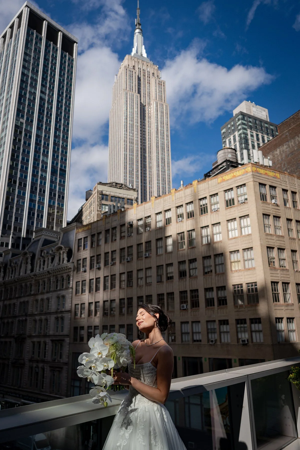 Bride on rooftop terrace with Empire State Building Virgin Hotels NYC