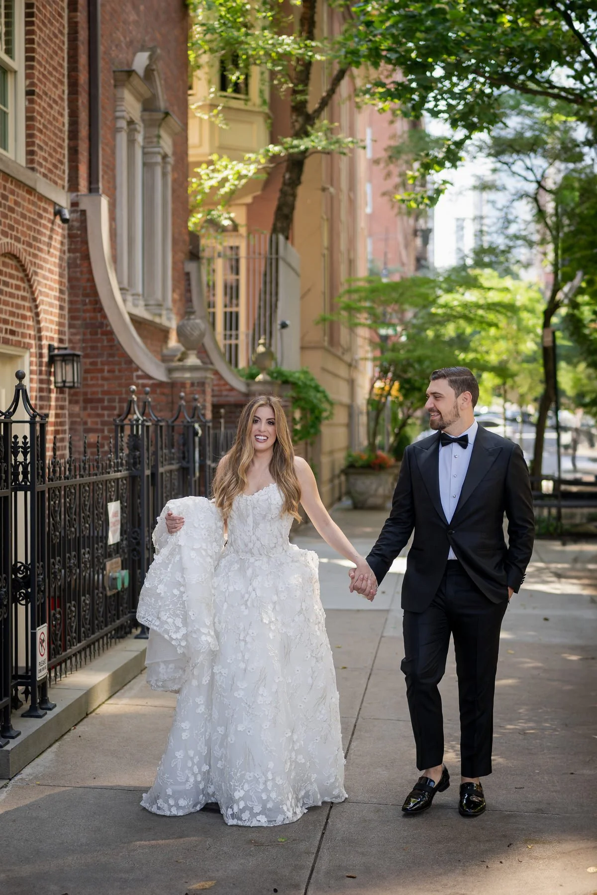 Bride and groom walking outside Guastavinos Upper East Side NYC