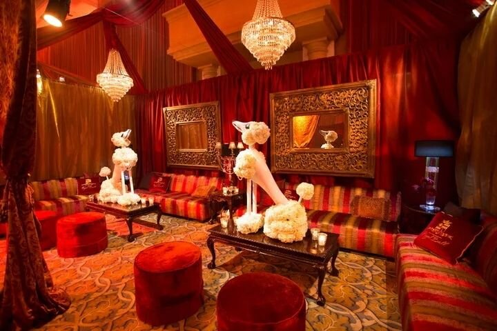 How to create a sexy vibe in a hotel ballroom -- bring the house lights down, add amber uplighting and use a rich event color palette of&nbsp;burgundy, gold, brown and oranges. 

LED fixtures around the perimeter of the ballroom were programmed to tr