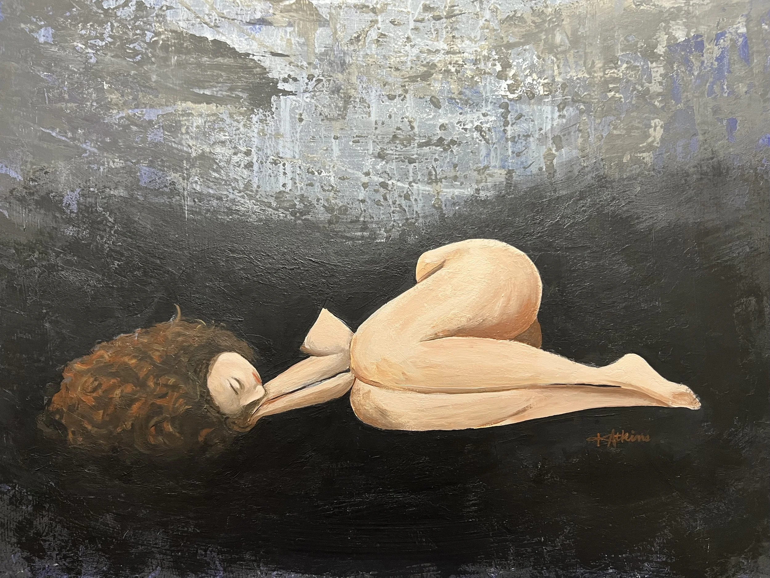 Close up image of the woman in the painting. She is laying on the ground curled up.