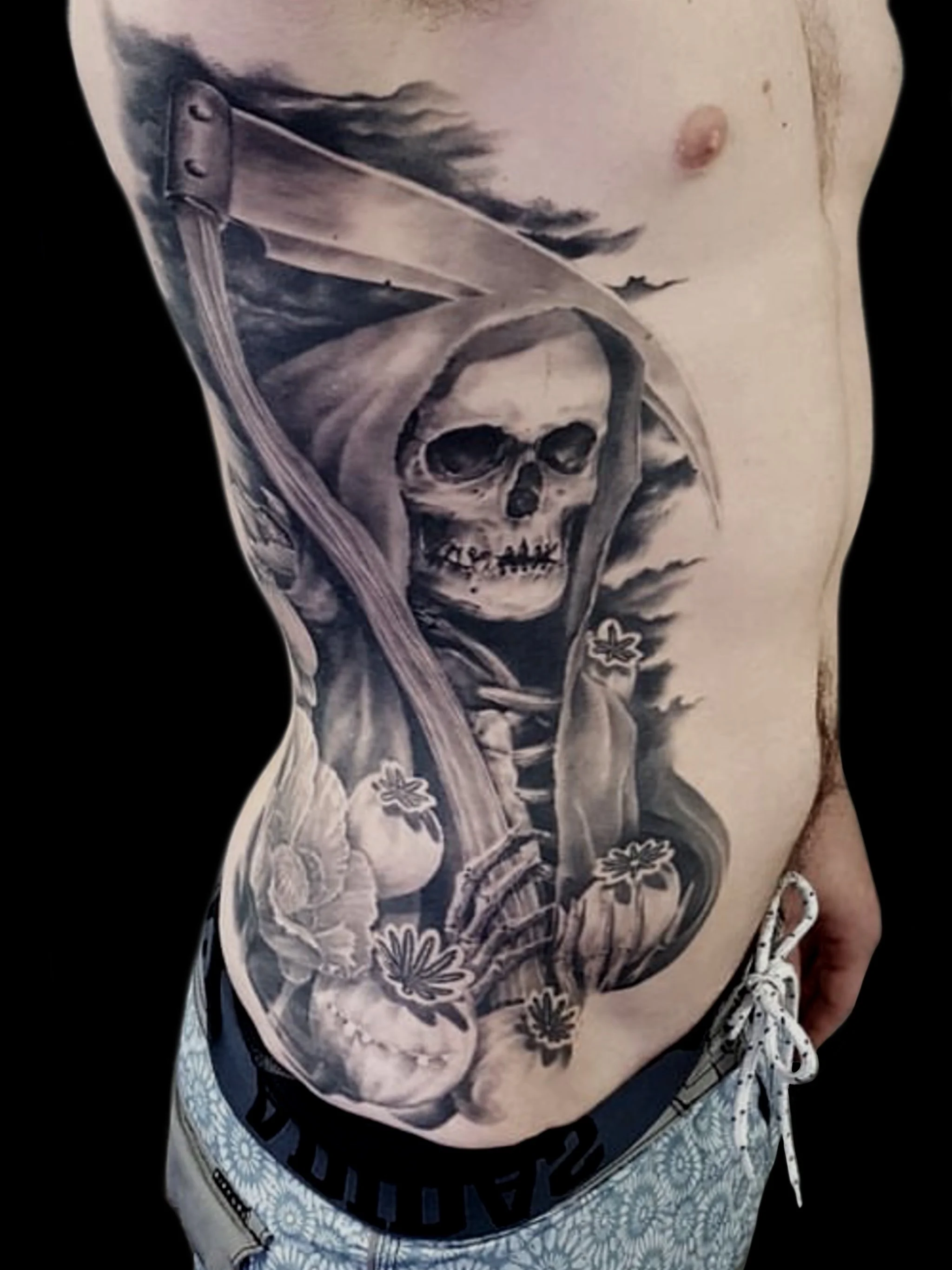 billy_sarno_huntington_beach_tattoo_black_and_gray_portrait_realism_realistic_grim_reaper_skeleton_scythe_poppy_poppy_buds_side_rib.JPG