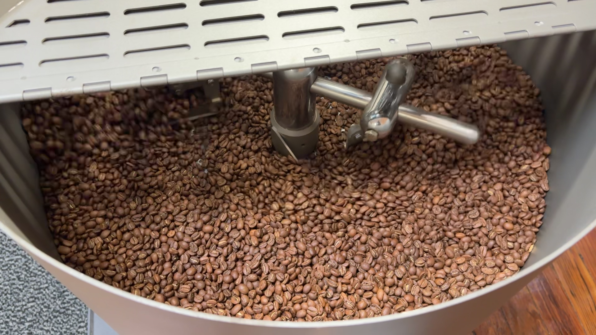 Coffee roasted to medium brown in cooling tray.png
