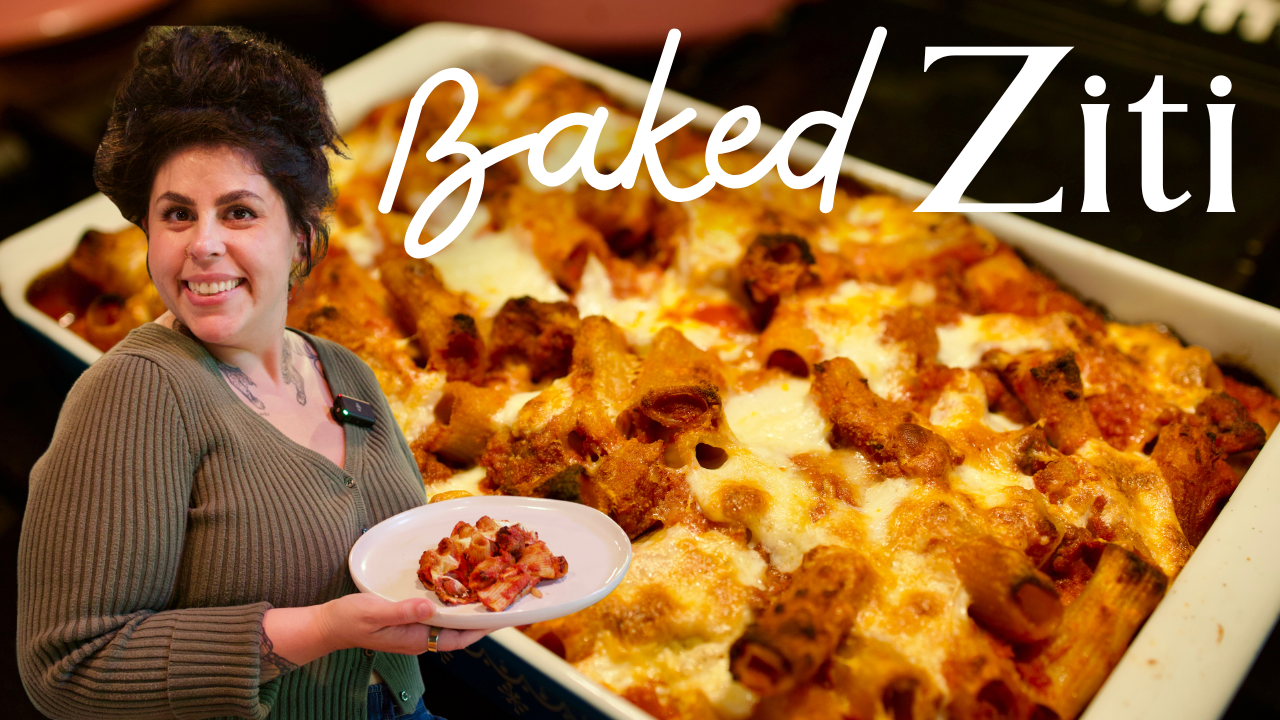 Mila holding a plate of baked ziti.