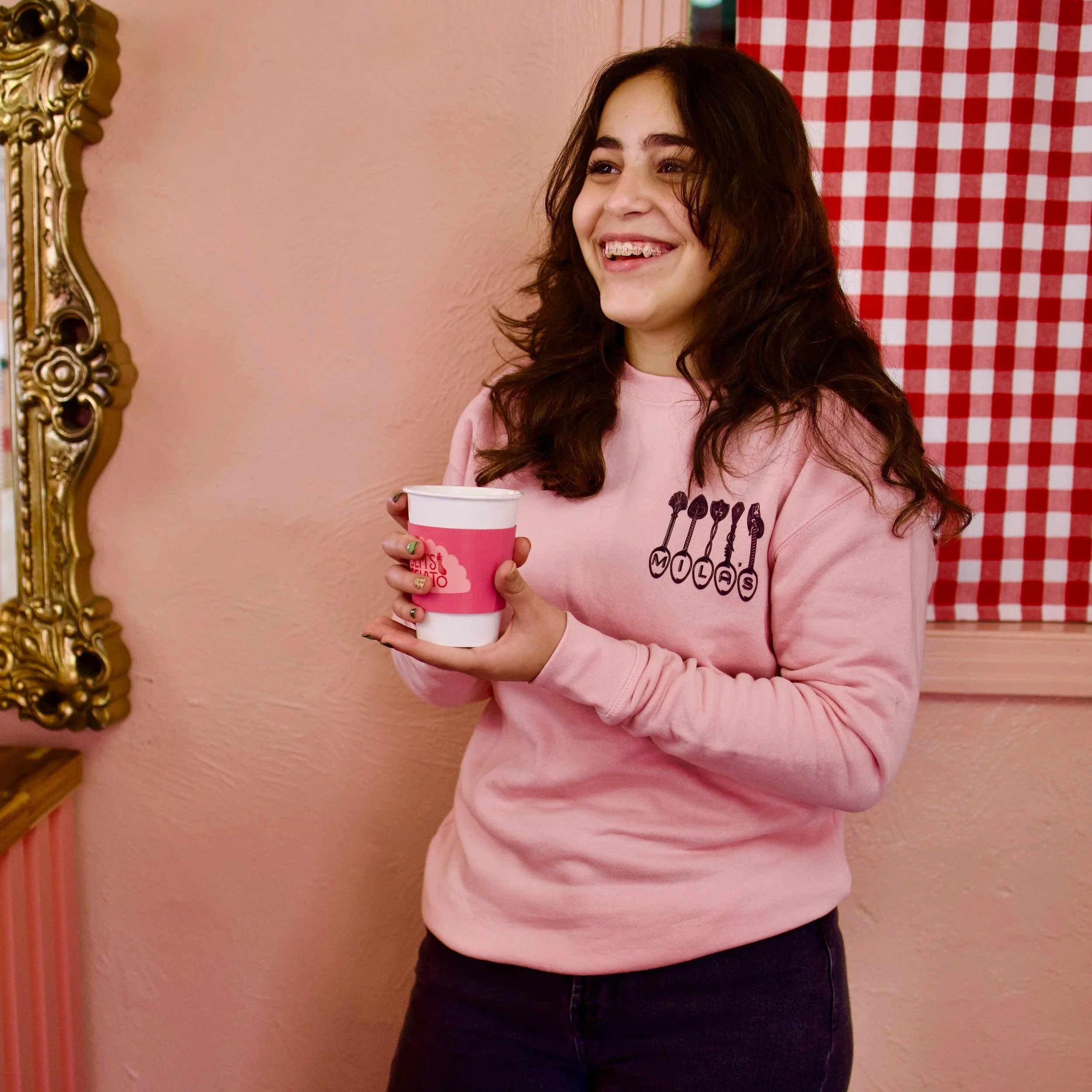 Light pink sweatshirts with vintage spoons spelling out "Mila's"