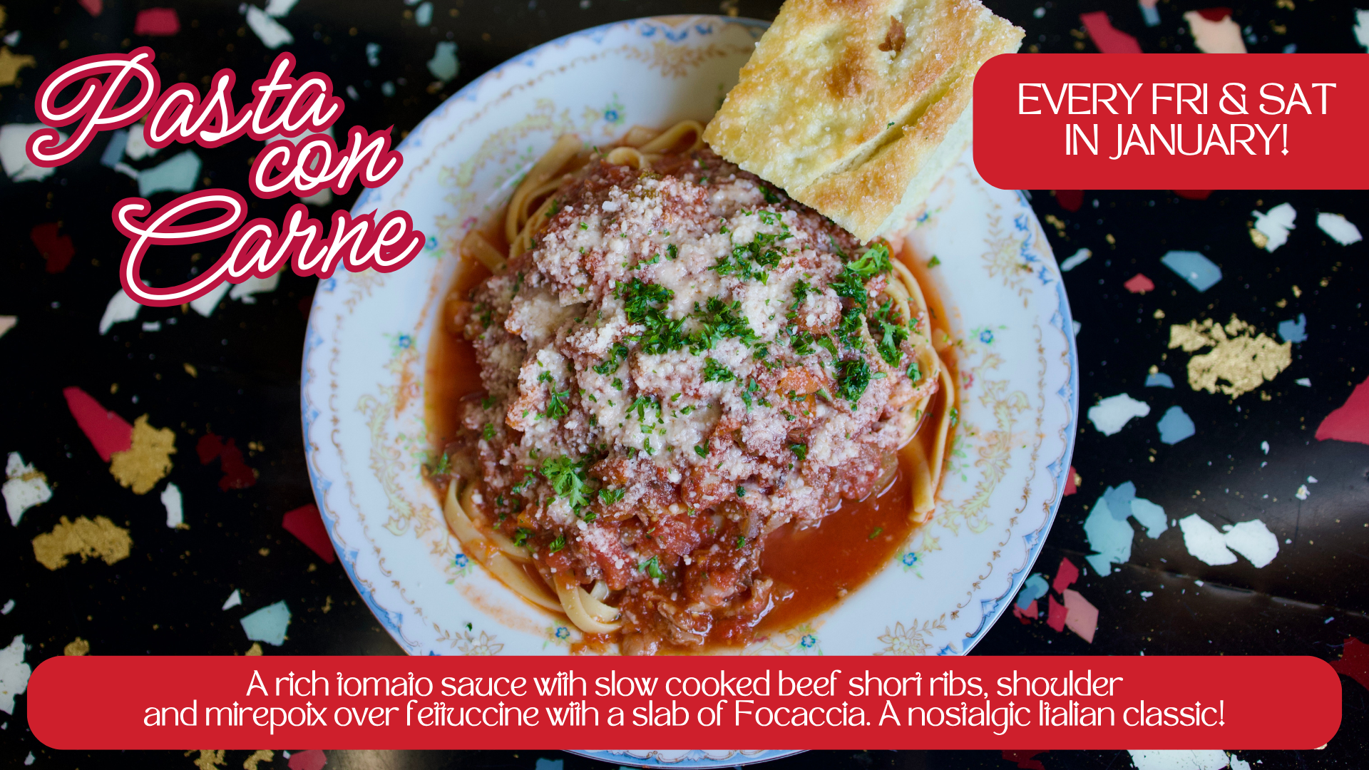 A plate of pasta with meat sauce garnished with parsley, with a piece of garlic bread on the side, on a festive black tablecloth with confetti.