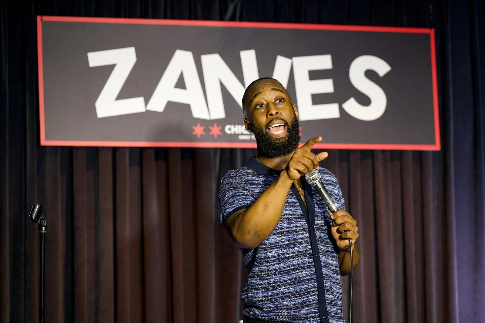St. James Jackson pointing toward the audience while performing at Zanies.