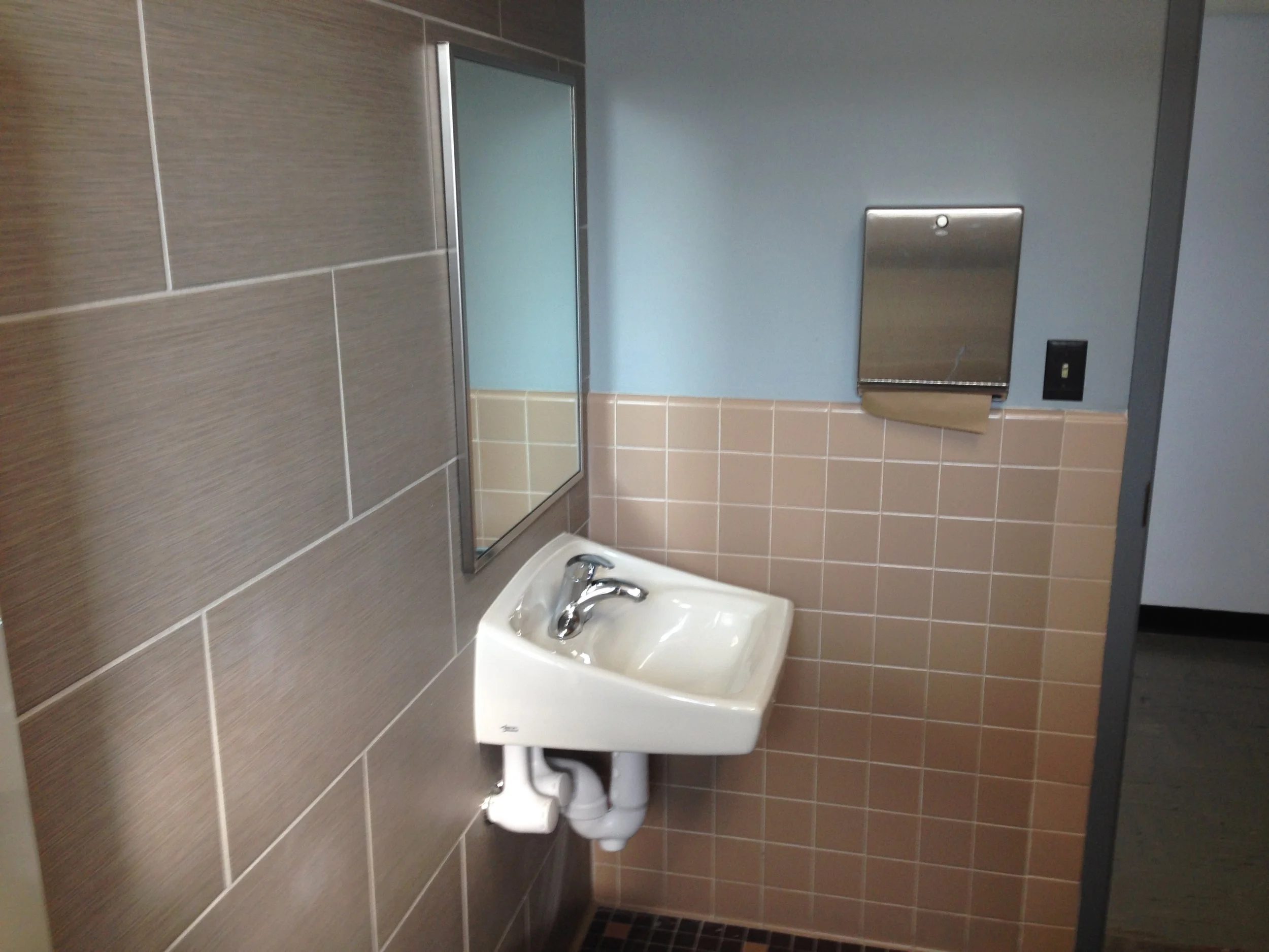Updated sink and backsplash in a remodeled church bathroom.JPG
