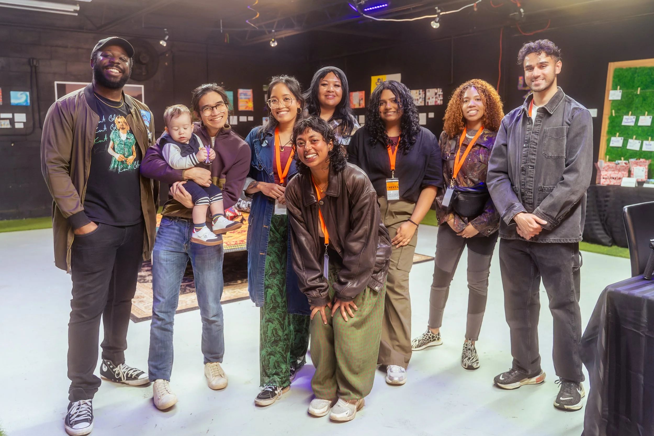 Another photo of 9 people smiling in front of the camera. 