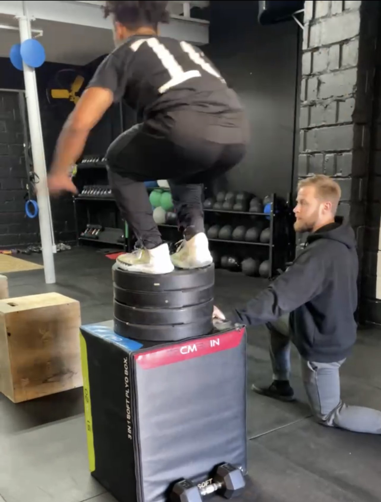 Athlete doing a box jump with a coach spotting, Char Sports Performance Montclair NJ