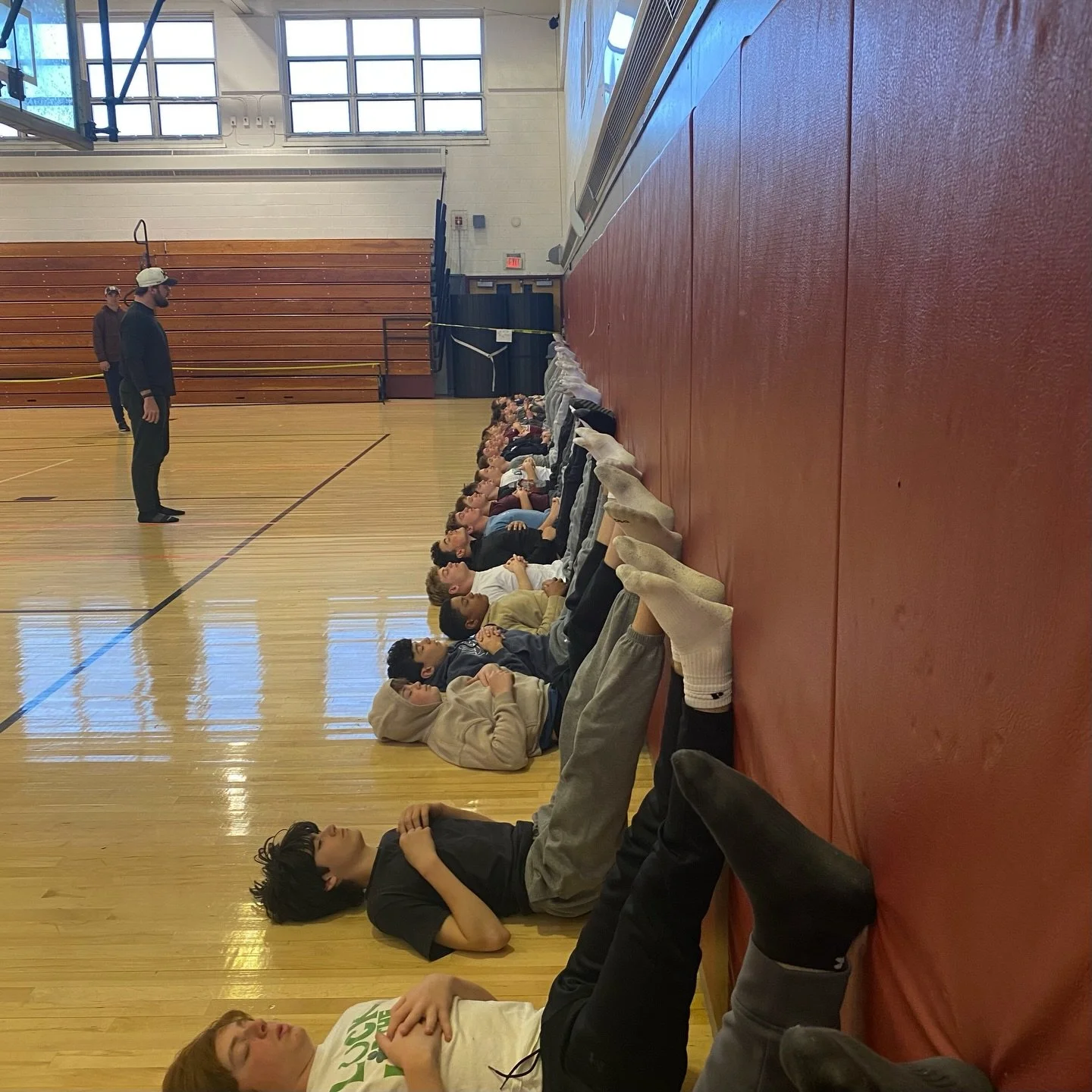 High school lacrosse team partner stretching in a Char Sports Performance recovery session, Montclair, NJ
