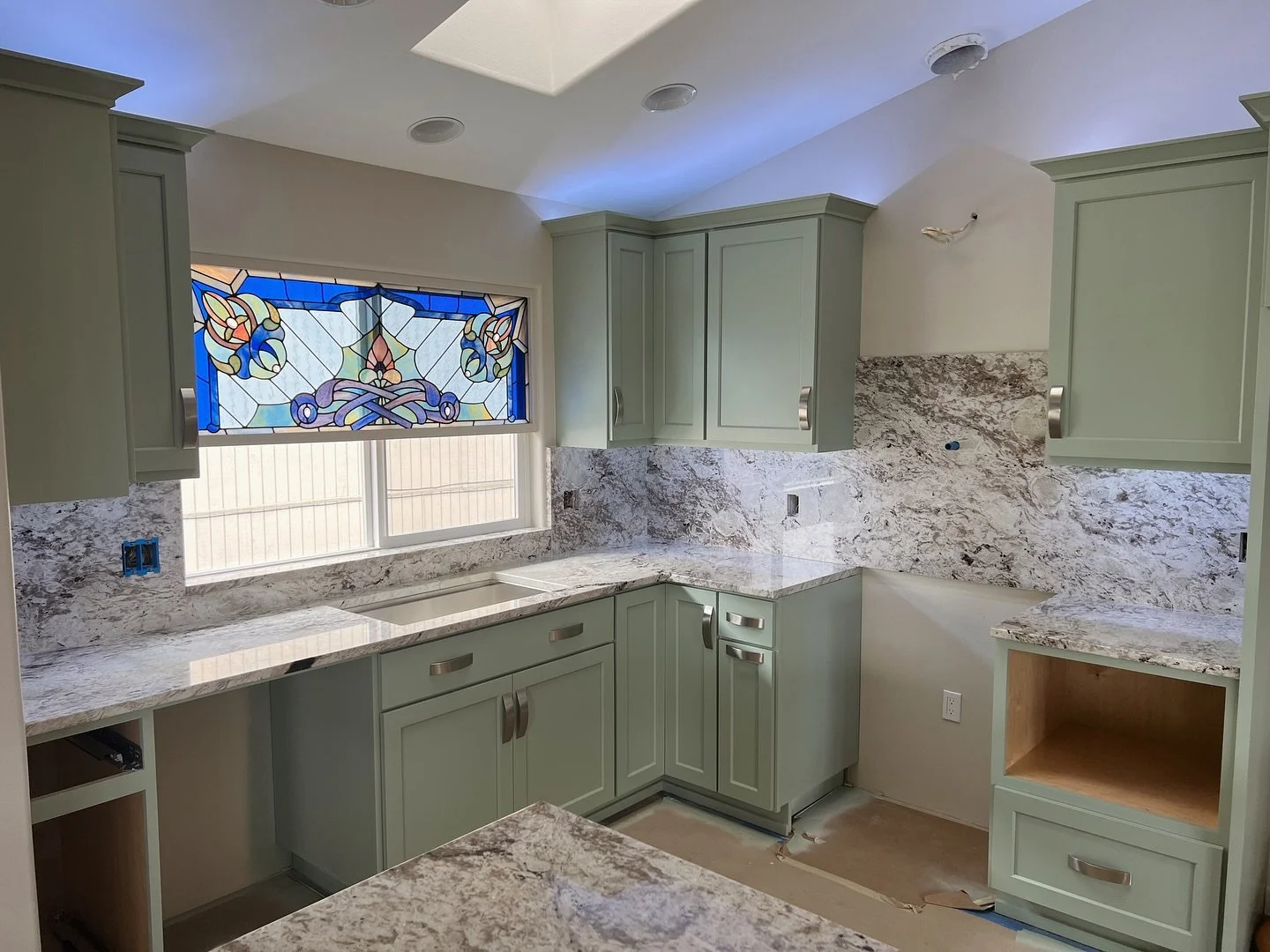This stunning Bluzonite granite kitchen 😮&zwj;💨 Love the way this granite pairs with the colored cabinets! #granitekitchencountertops #kitchenremodelingideas #granitecountertops #thehausgraniteco #remodeledhome #kitcheninspiration #homeremodelingid