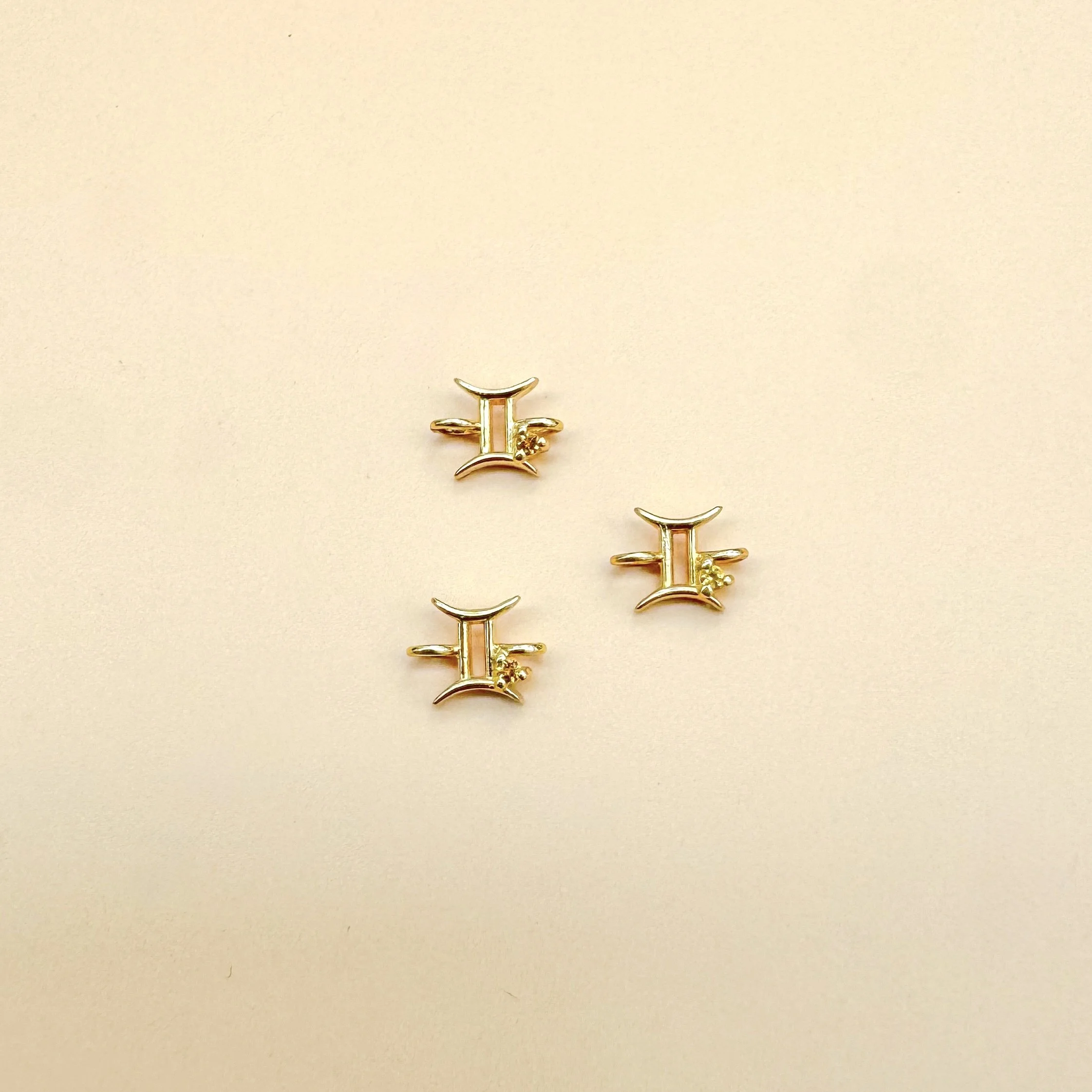 Gemini zodiac charm in solid 14k gold with natural citrine birthstone. Permanent jewelry by The Sparkle Bar, Edmonton. Shop zodiac connectors online