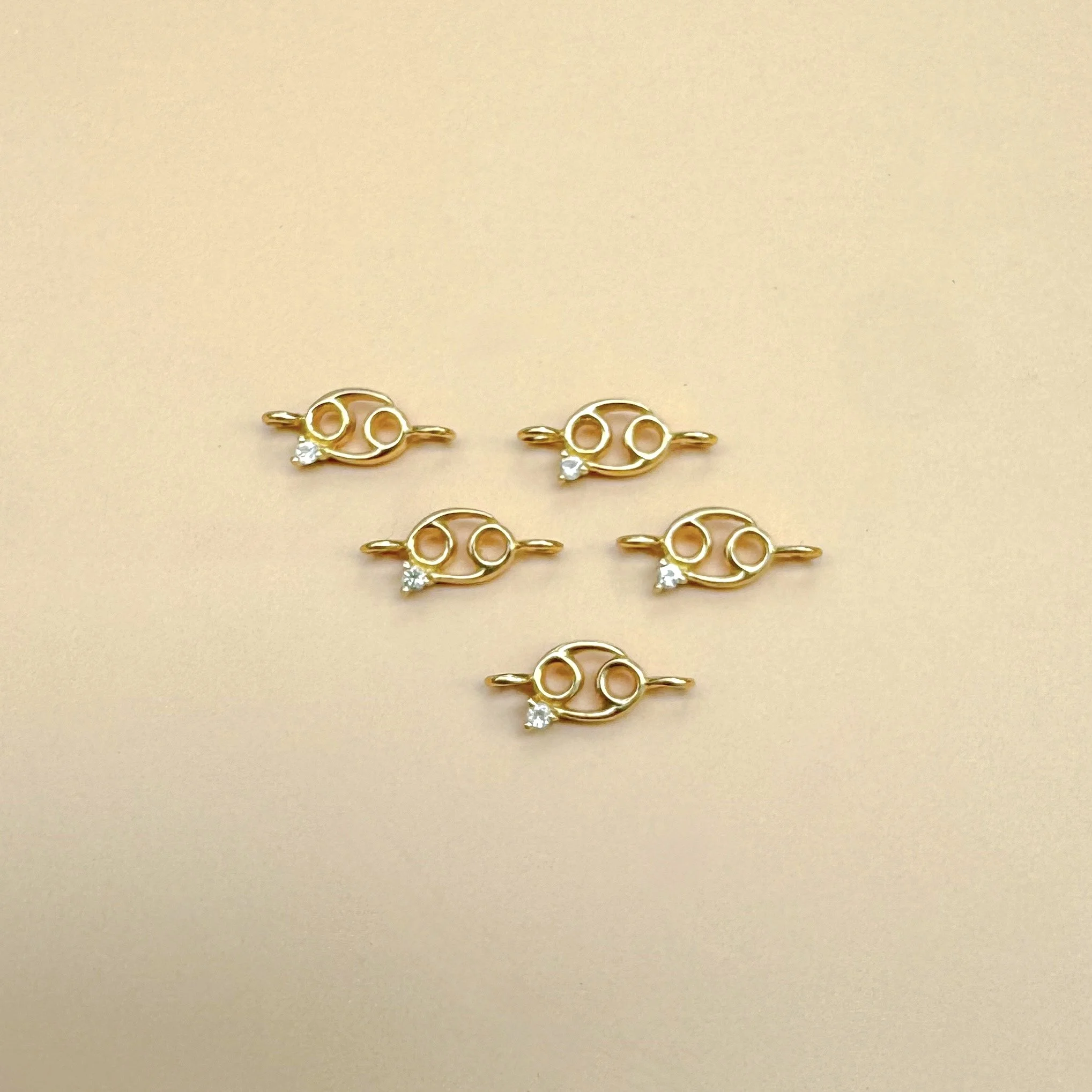 Cancer zodiac charm in solid 14k gold with natural moonstone birthstone. Permanent jewelry by The Sparkle Bar, Edmonton. Shop zodiac connectors online