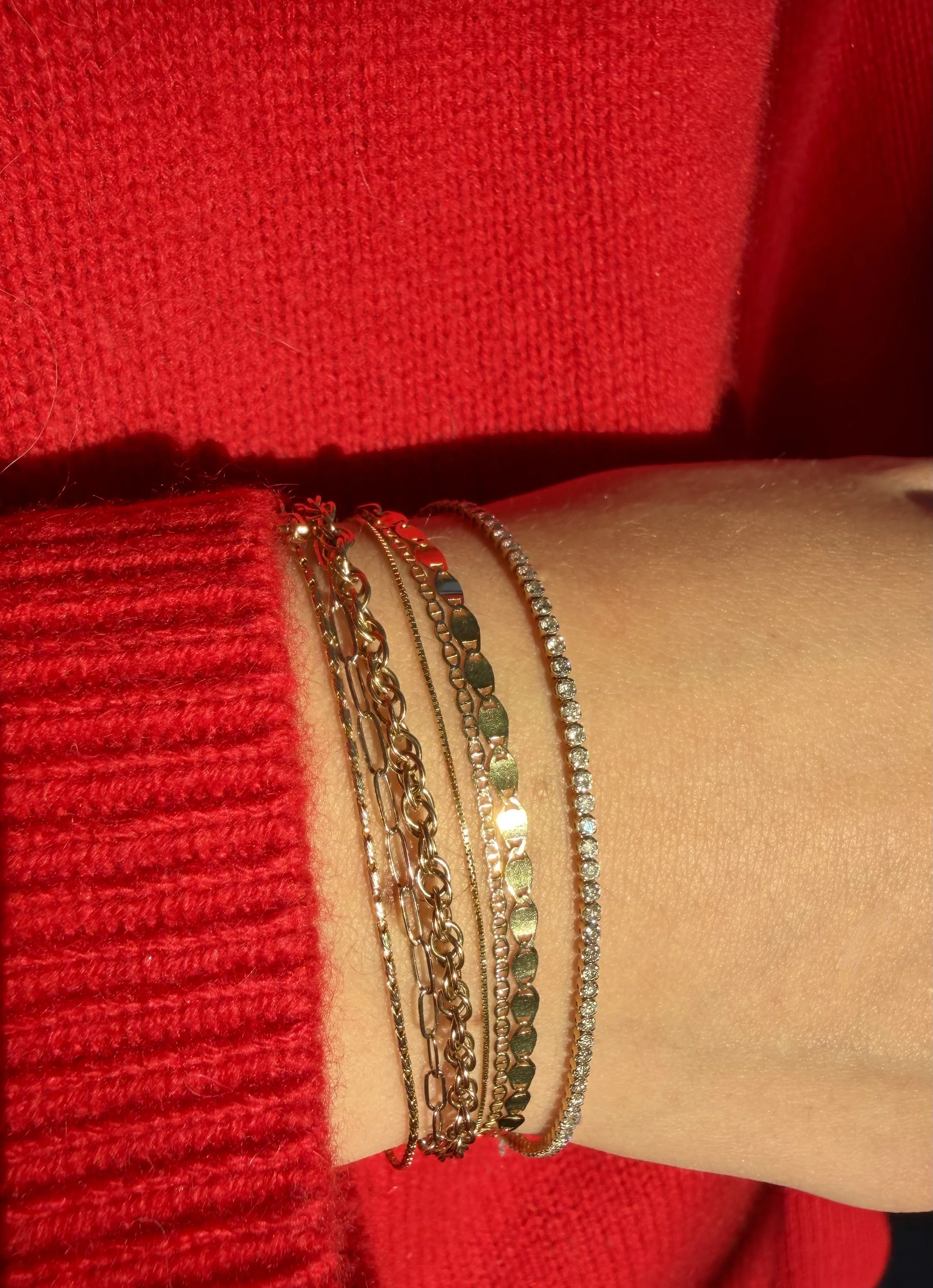 Diamond tennis bracelet layered with a  solid 14k gold permanent jewelry from The Sparkle Bar in Edmonton