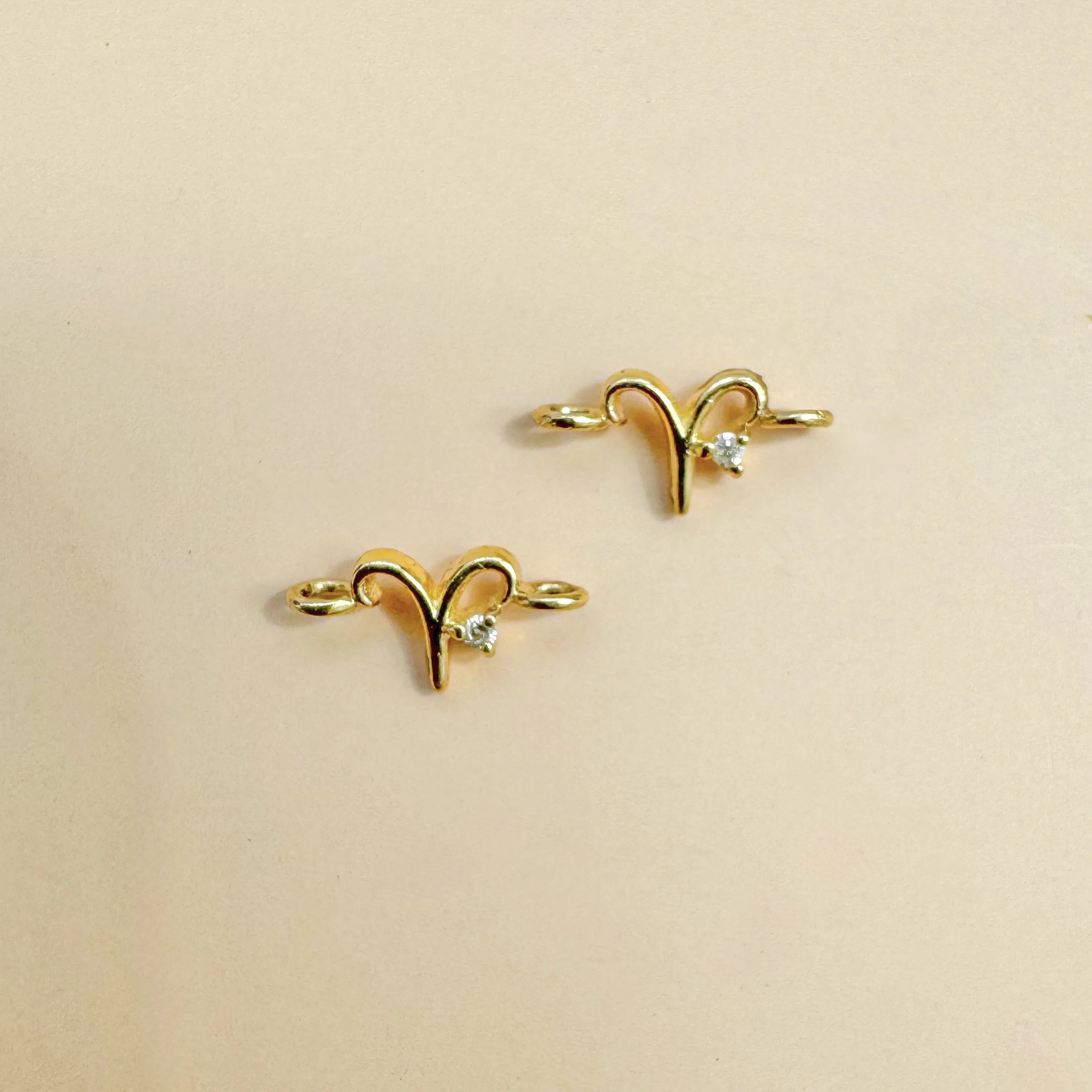 Aries zodiac charm in solid 14k gold with natural diamond birthstone. Permanent jewelry by The Sparkle Bar, Edmonton. Shop zodiac connectors online