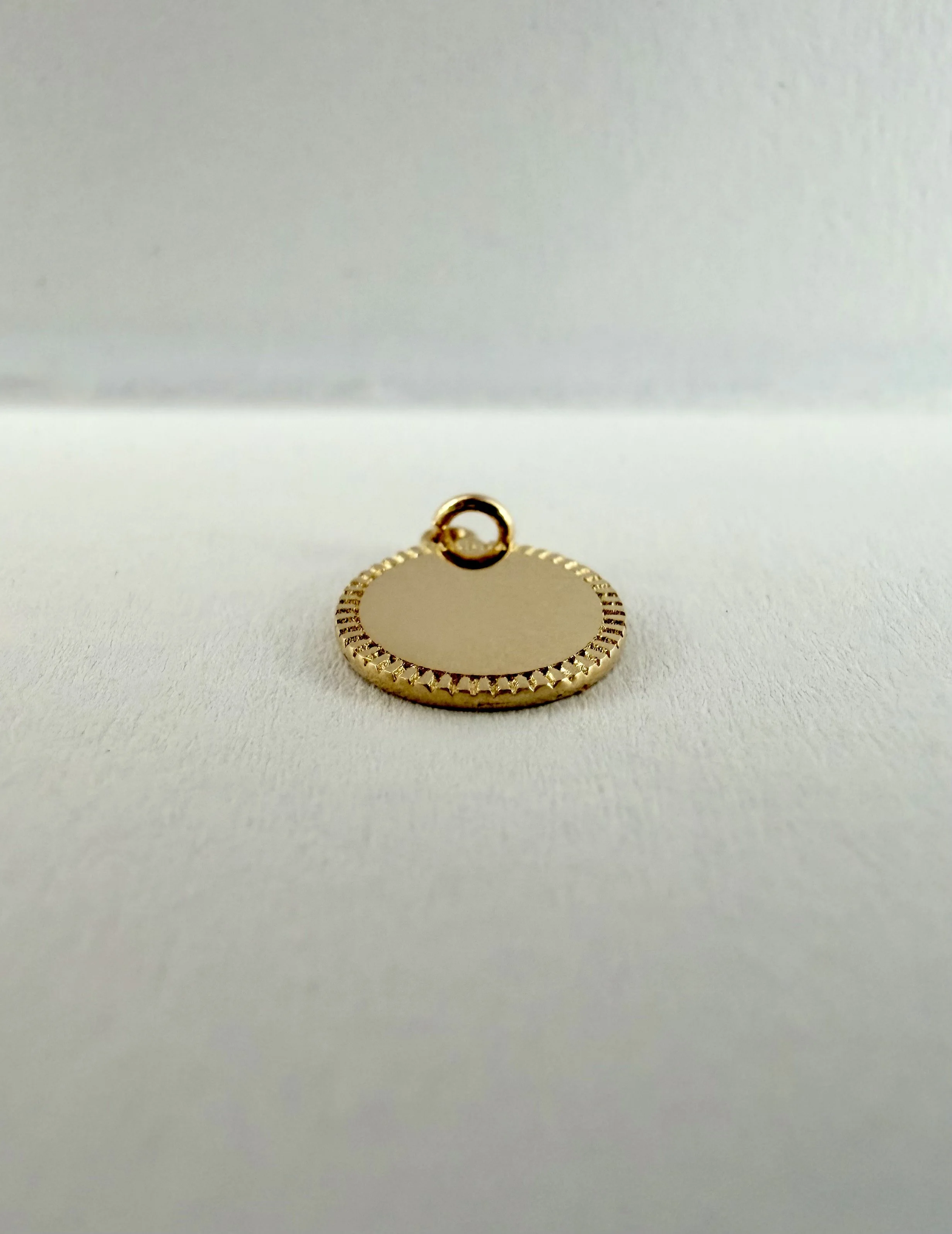 14k gold engravable Love Token charm shown in profile, polished surface for personalized engraving