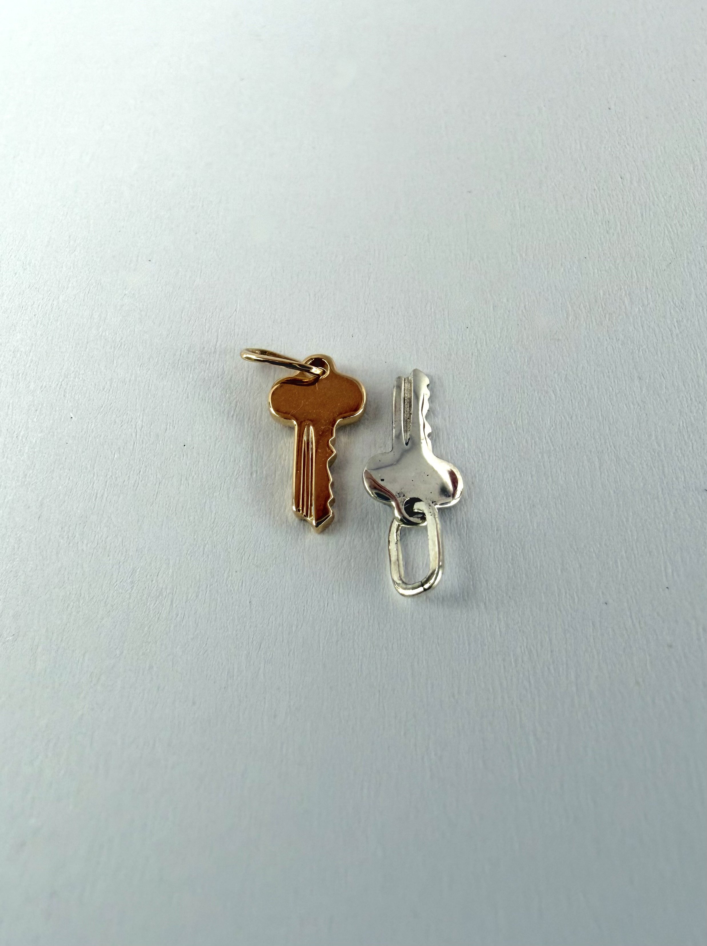 Sterling silver engravable key charm shown with gold version, small detailed pendant for custom engraving