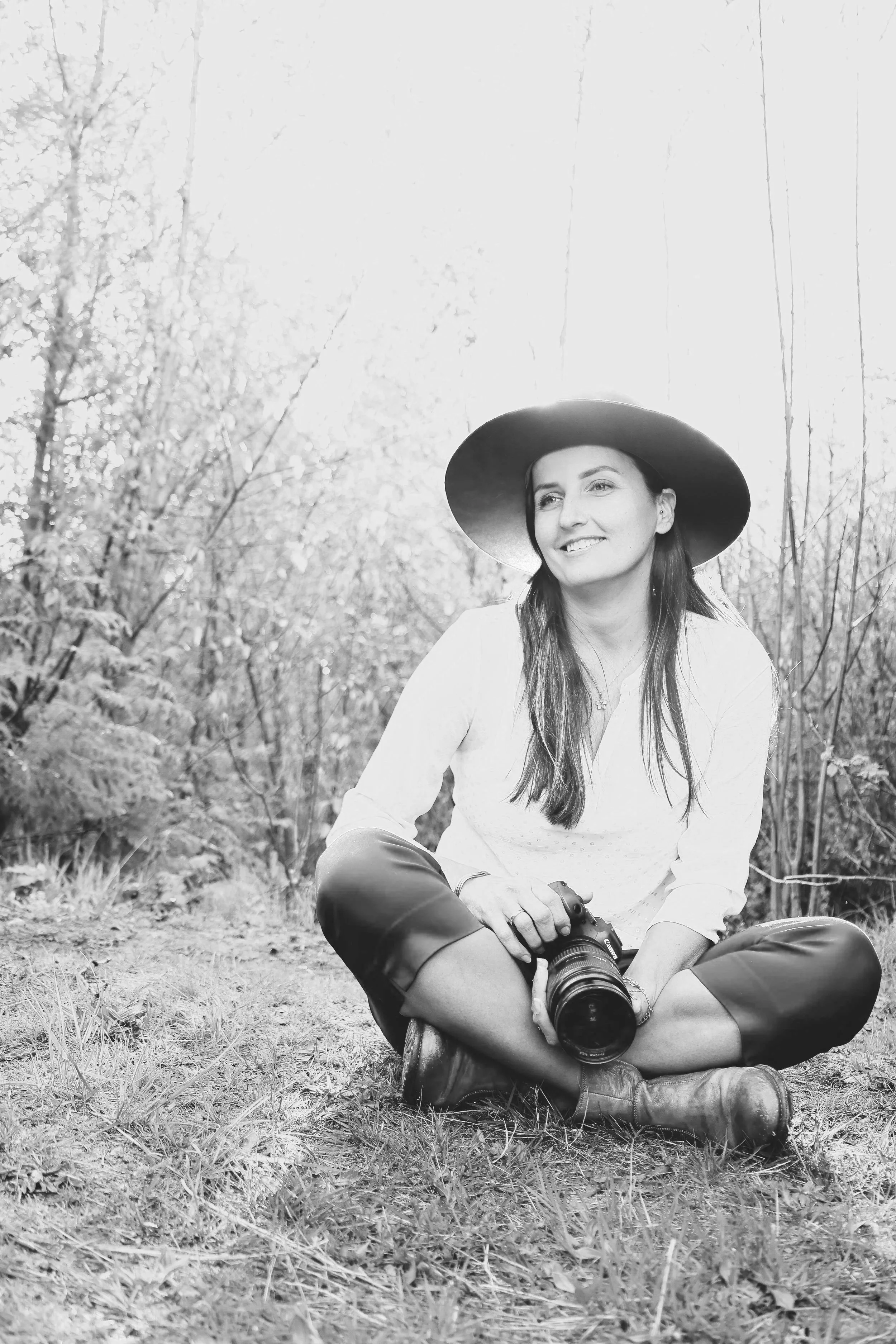 Bernadette Washington micro wedding photographer posing tin the woods of the North Cascades with camera