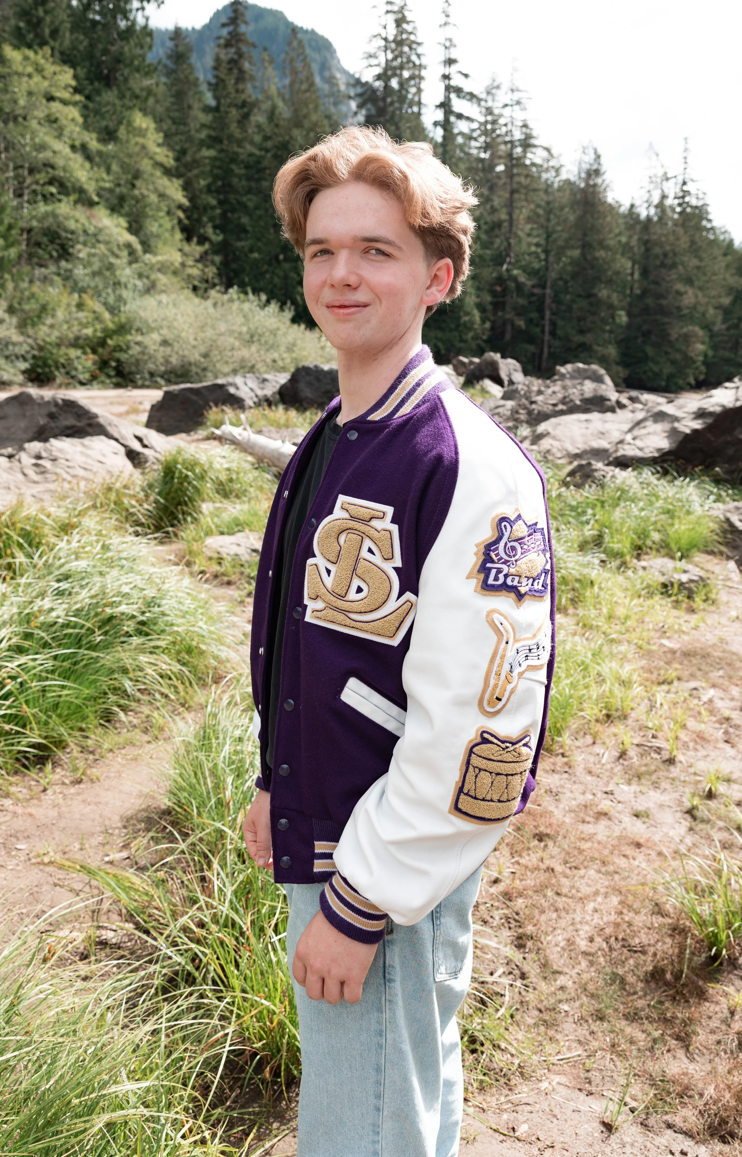 Lake Stevens High school senior guy in an outdoor adventure photo session. Wearing his Vikings letterman jacket.