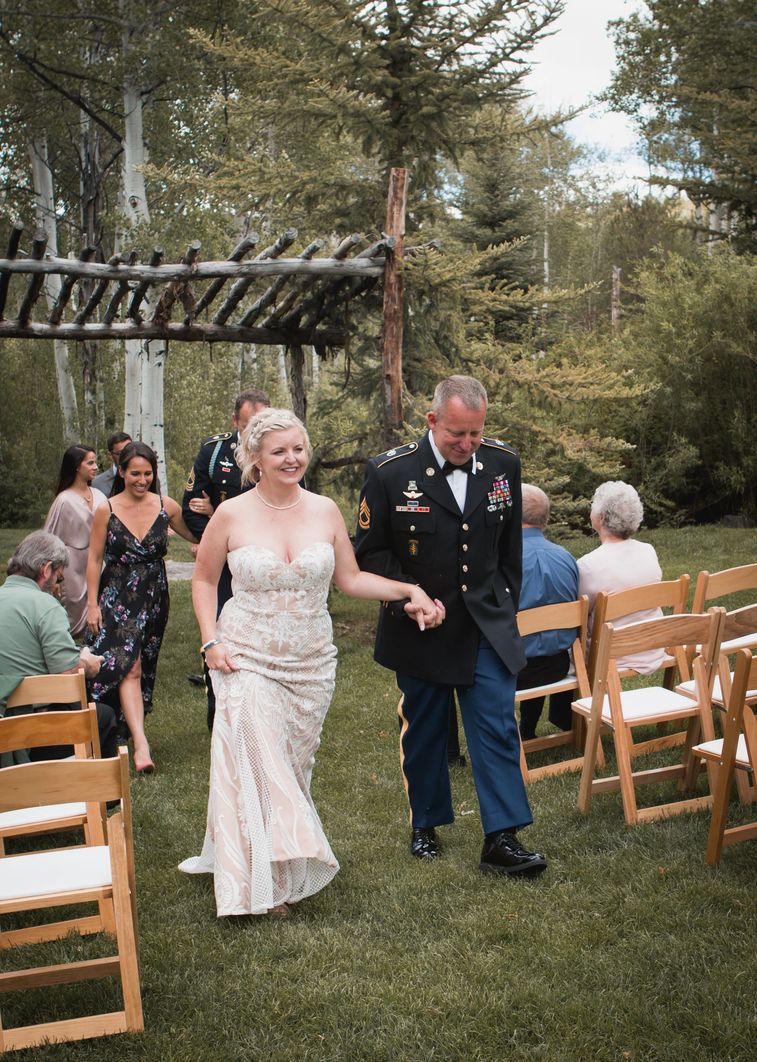 PNW Micro-Wedding in the woods, Snohomish WA Candid of couple walking back down isle smiling