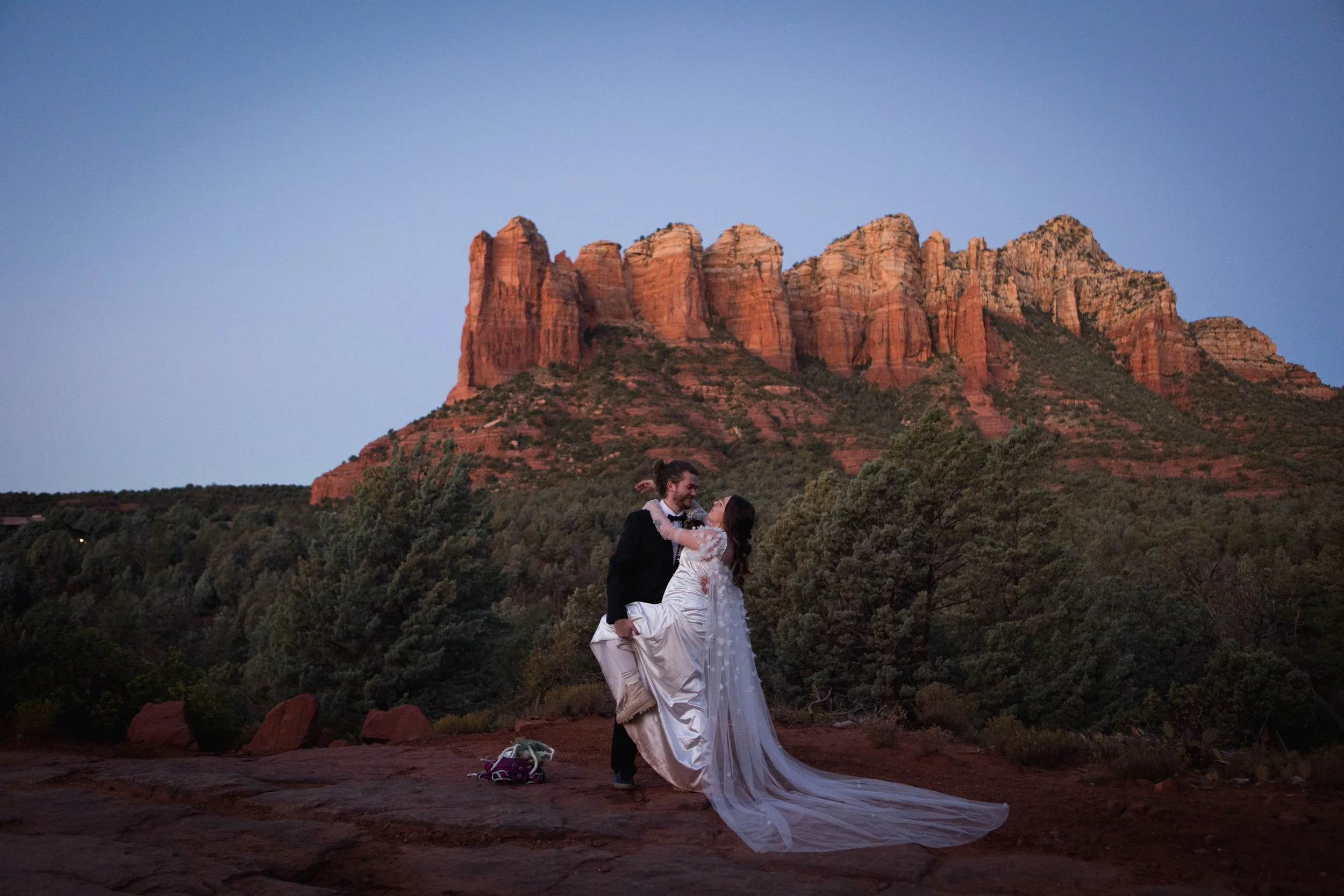 elopement couple hiking in red rock of Sedona at dawn