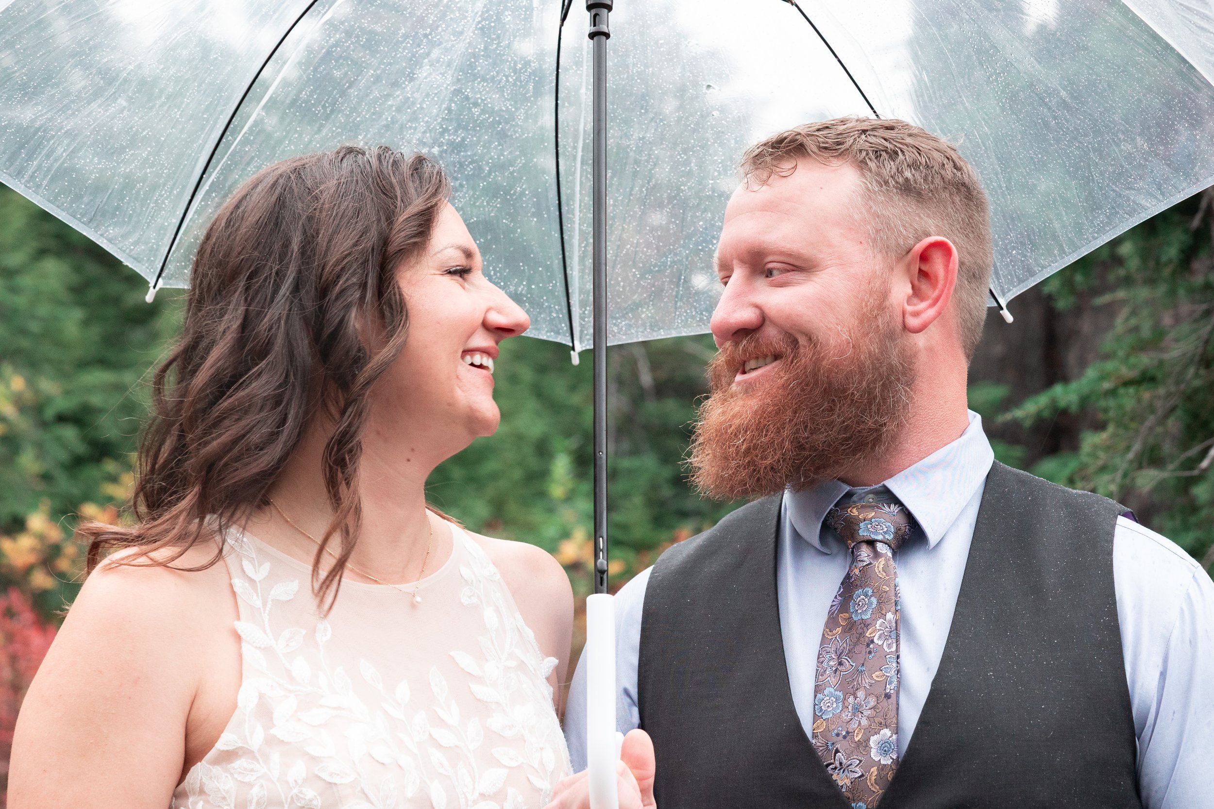 Mt.Baker Washington micro wedding couple under an umbrella looking and smiling at each other