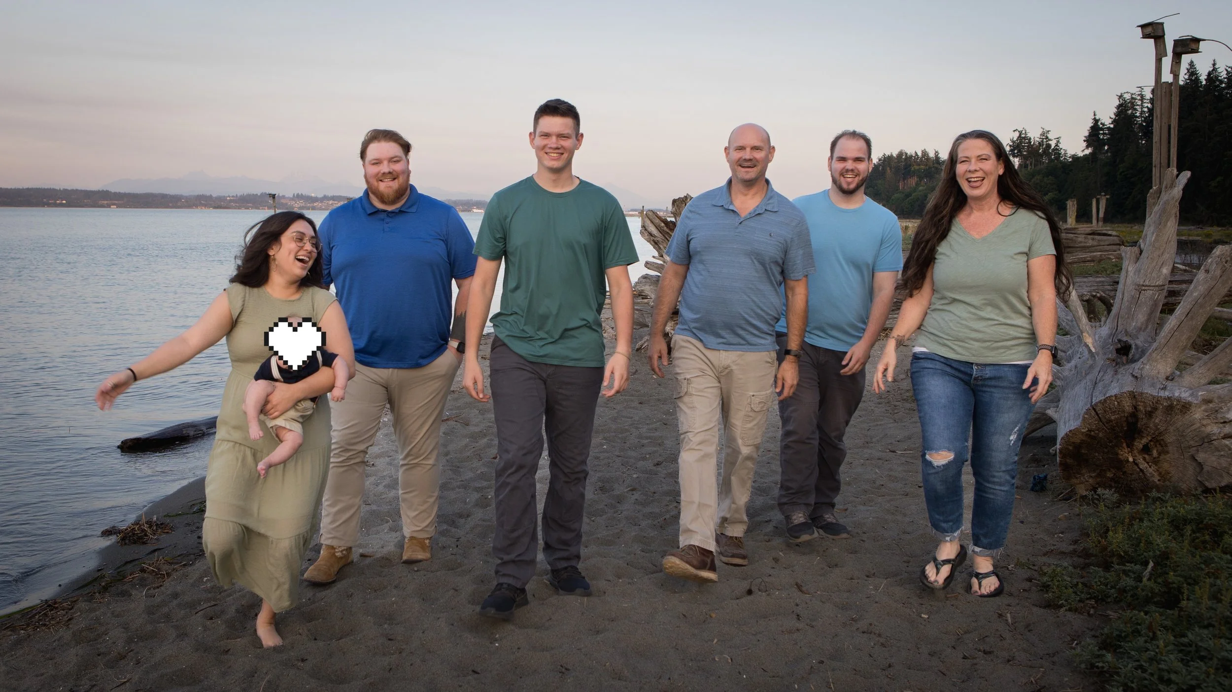 Adventure family shoot, family on the beach at Camano Island at sunset making goofy faces at each other and laughing.