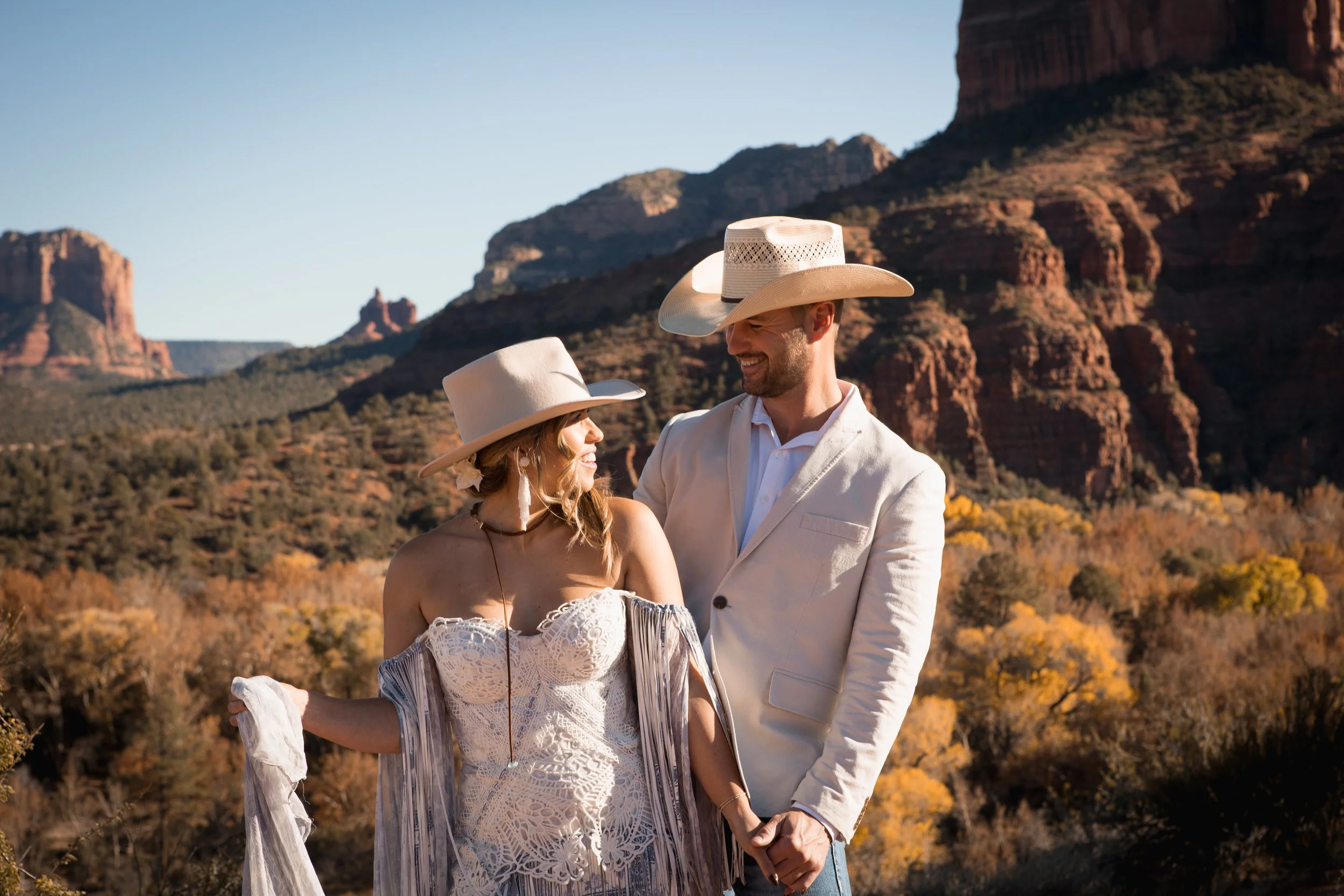western elopement couple smiling at each other in the Sedona red rock