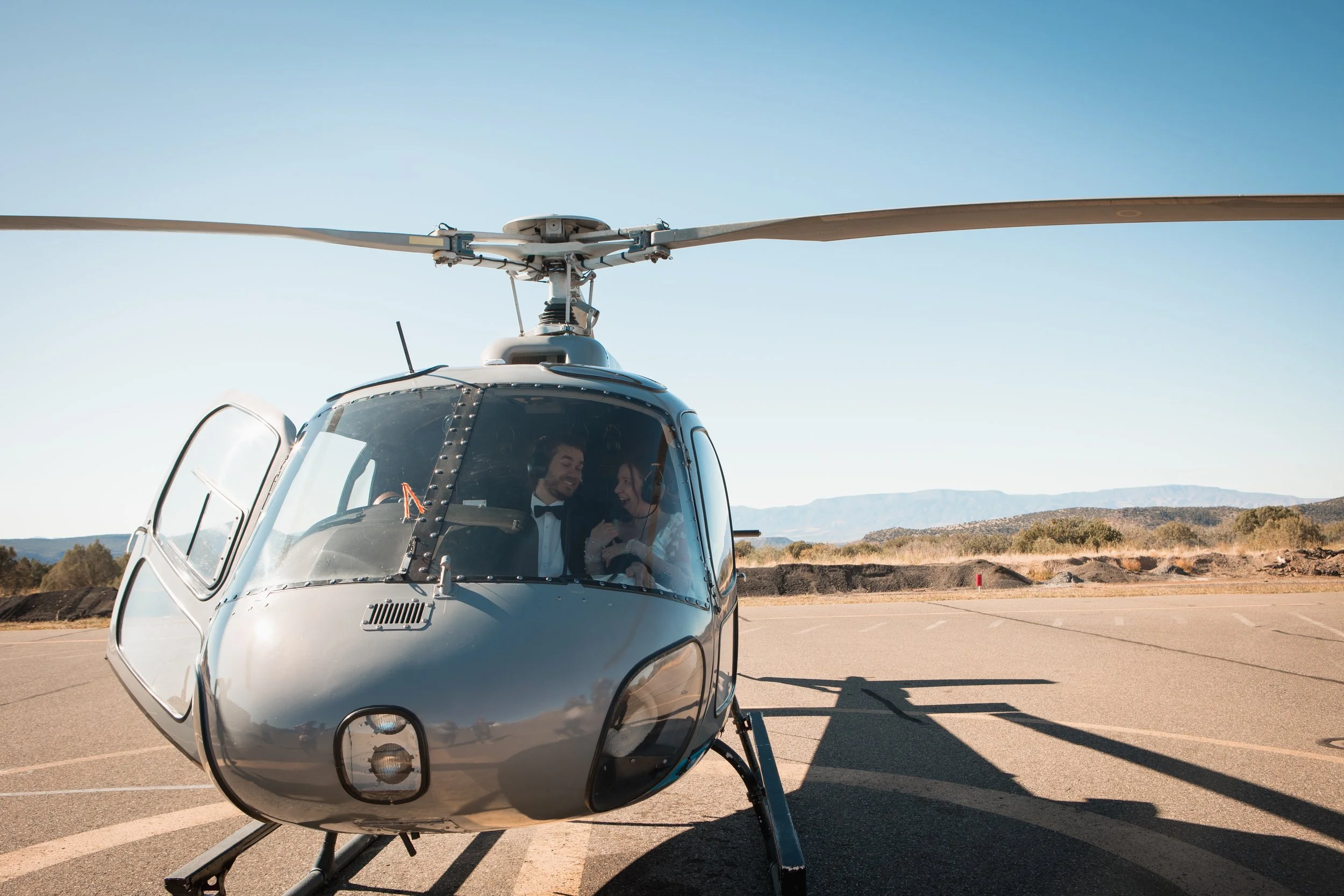 Sedona Elopement couple laughing in helicopter at Sedona airport