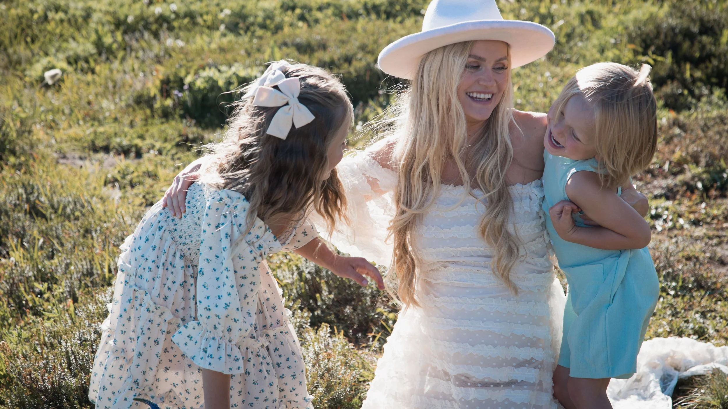 Snohomish family laughing together in a field of wild flowers