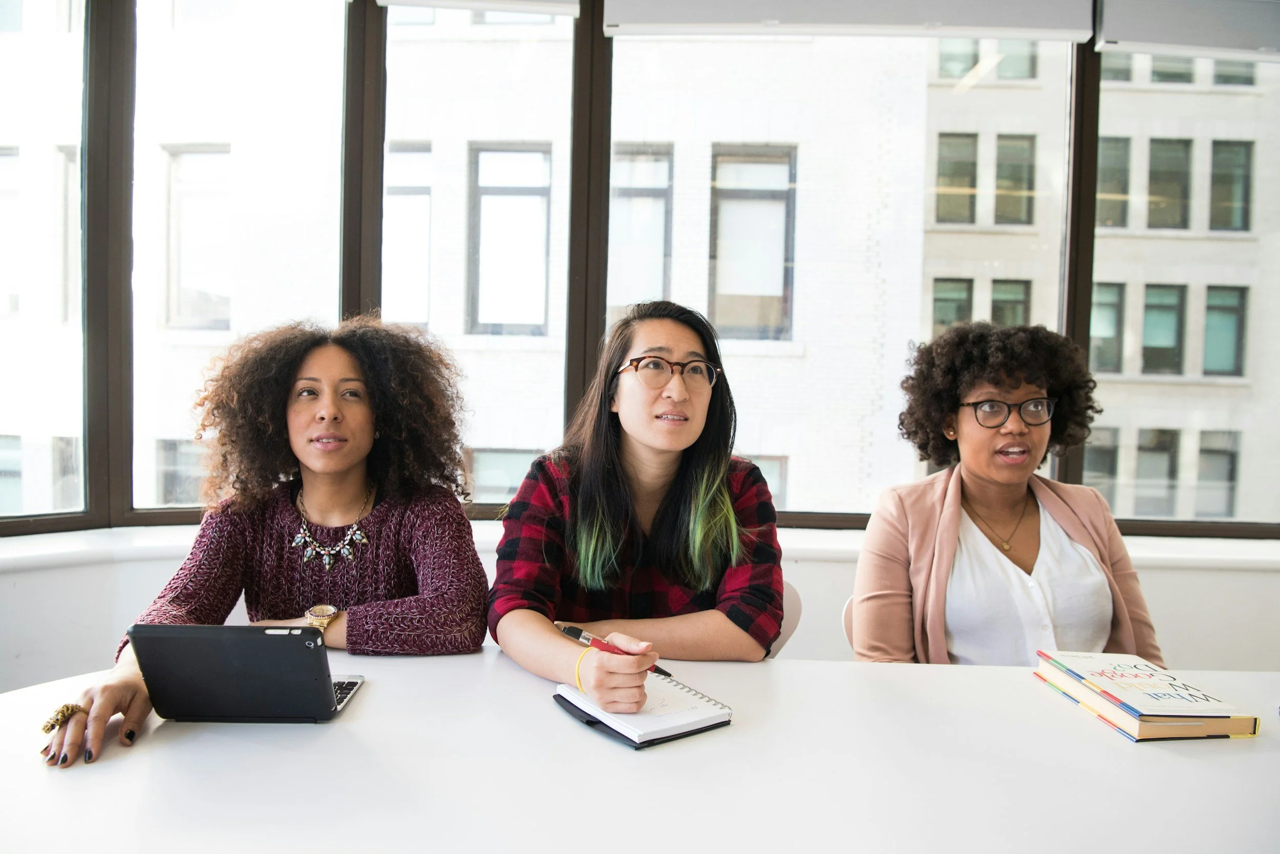 Group of employees engaged with mental health speaker for company, workplace wellness speaker, inspired by keynote on burnout, psychological safety expert.