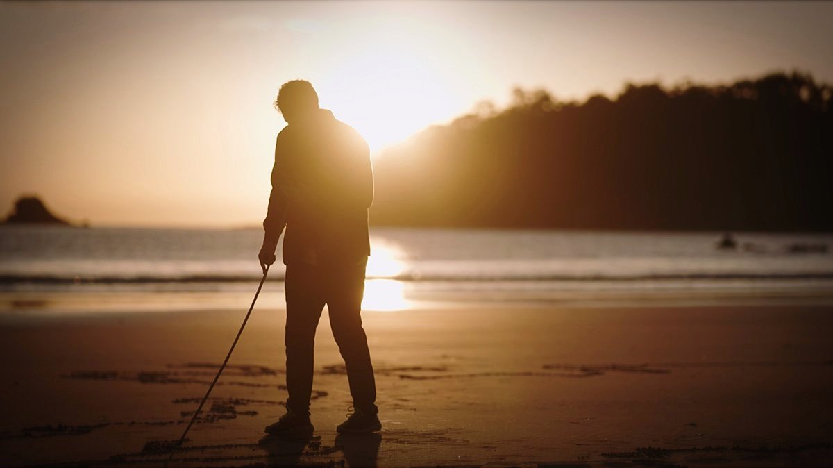 Backlit sunrise photo of Sand Artist Kenrick Smith