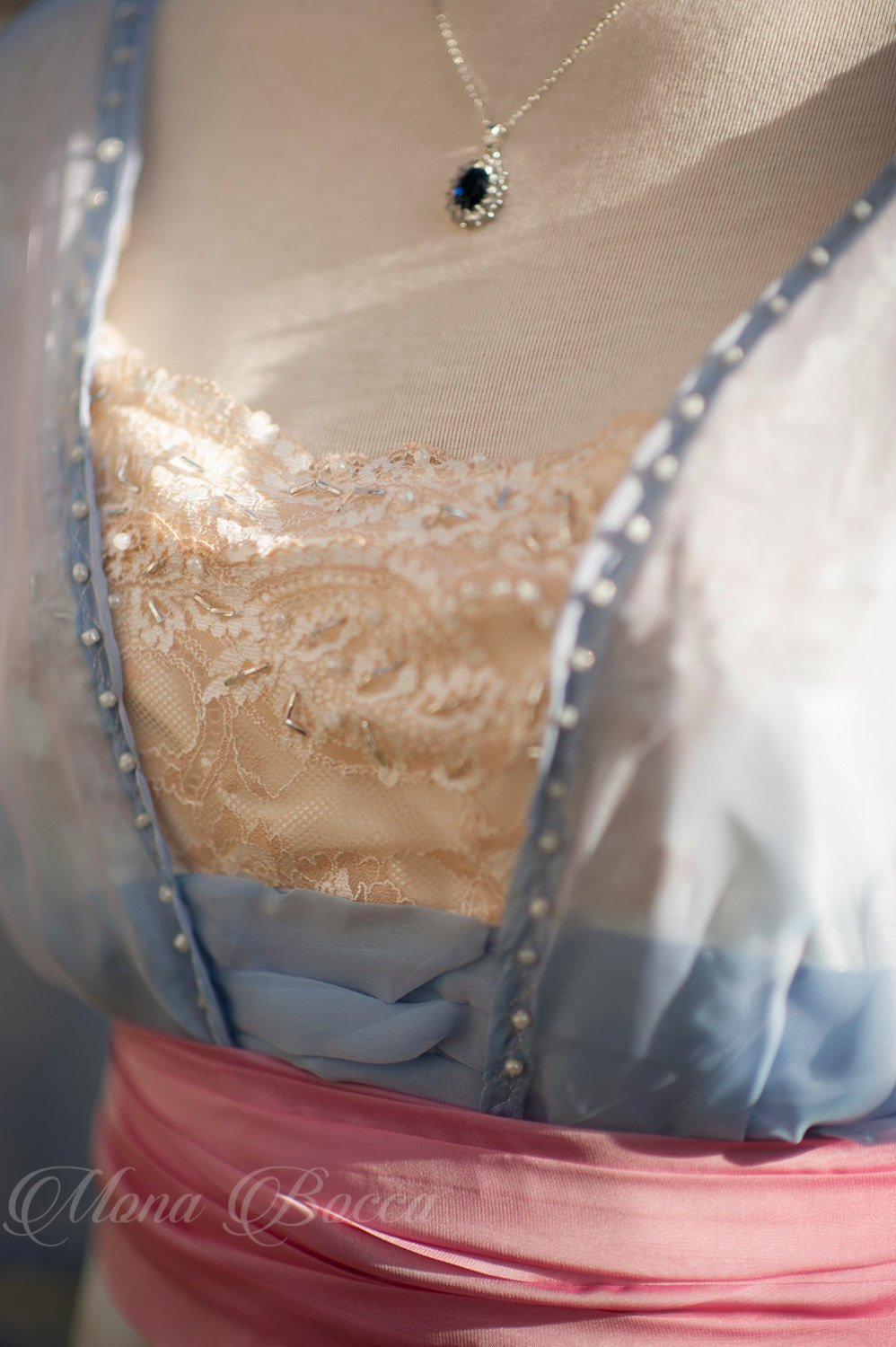 Close up od the bodice with lace and silver beads.