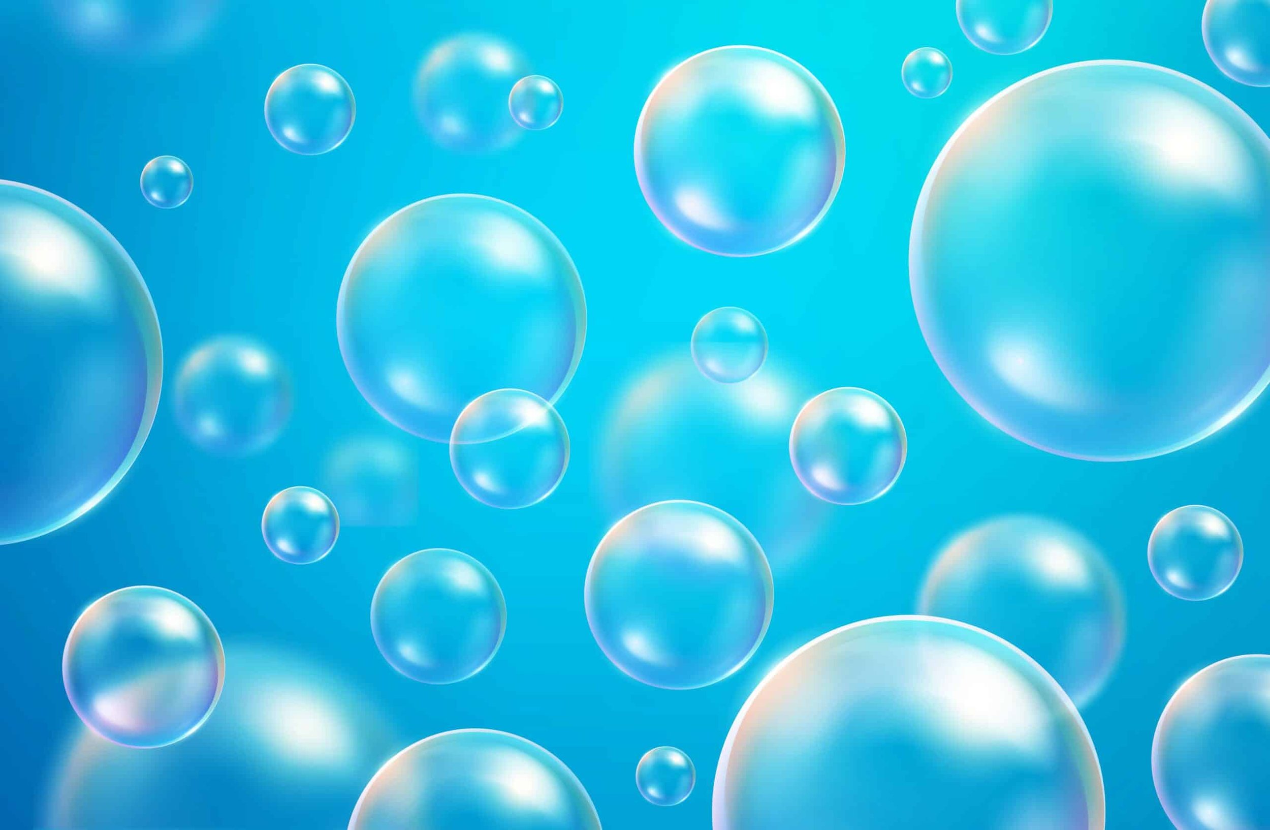 Multiple transparent bubbles of varying sizes floating against a blue background.