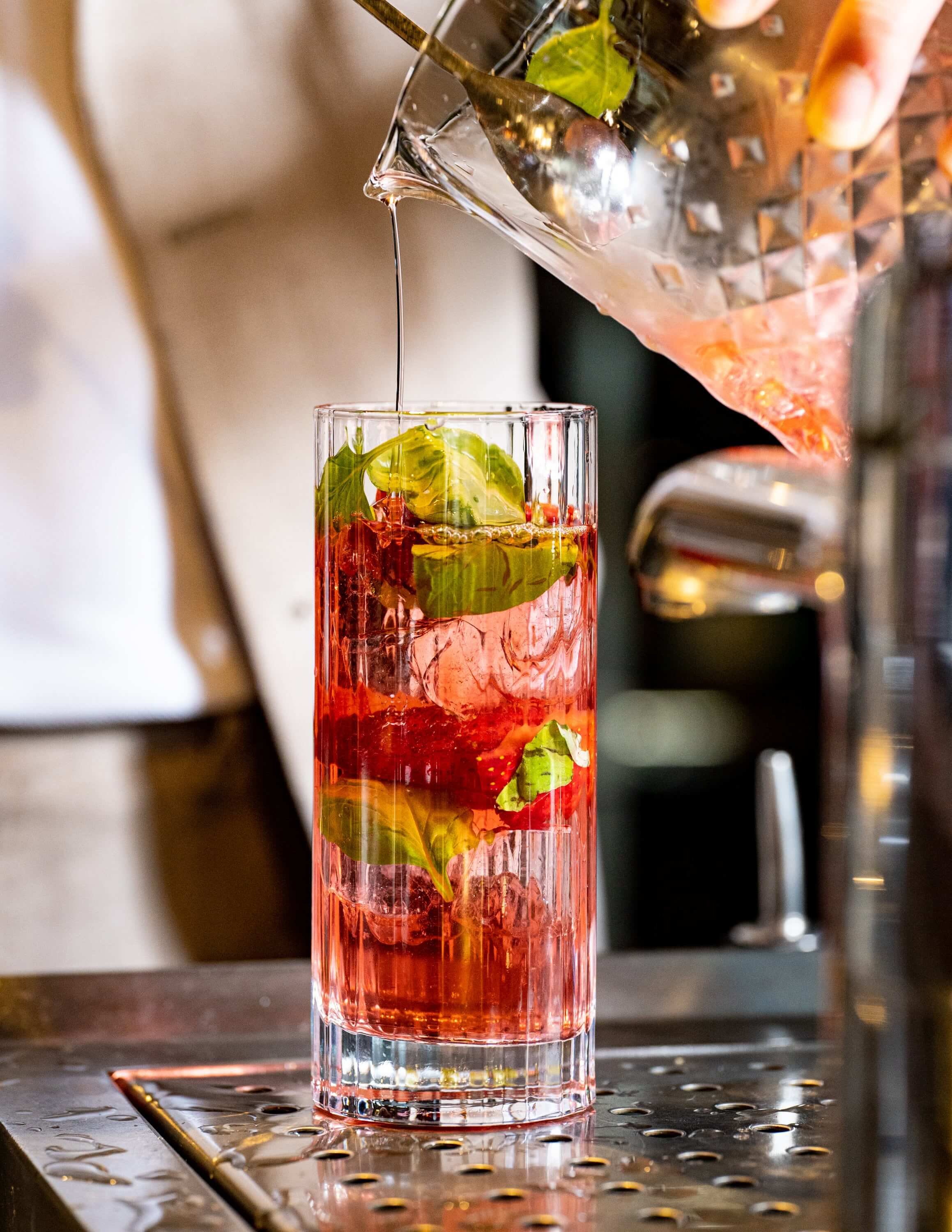 Tall glass filled with fruity fun cocktail