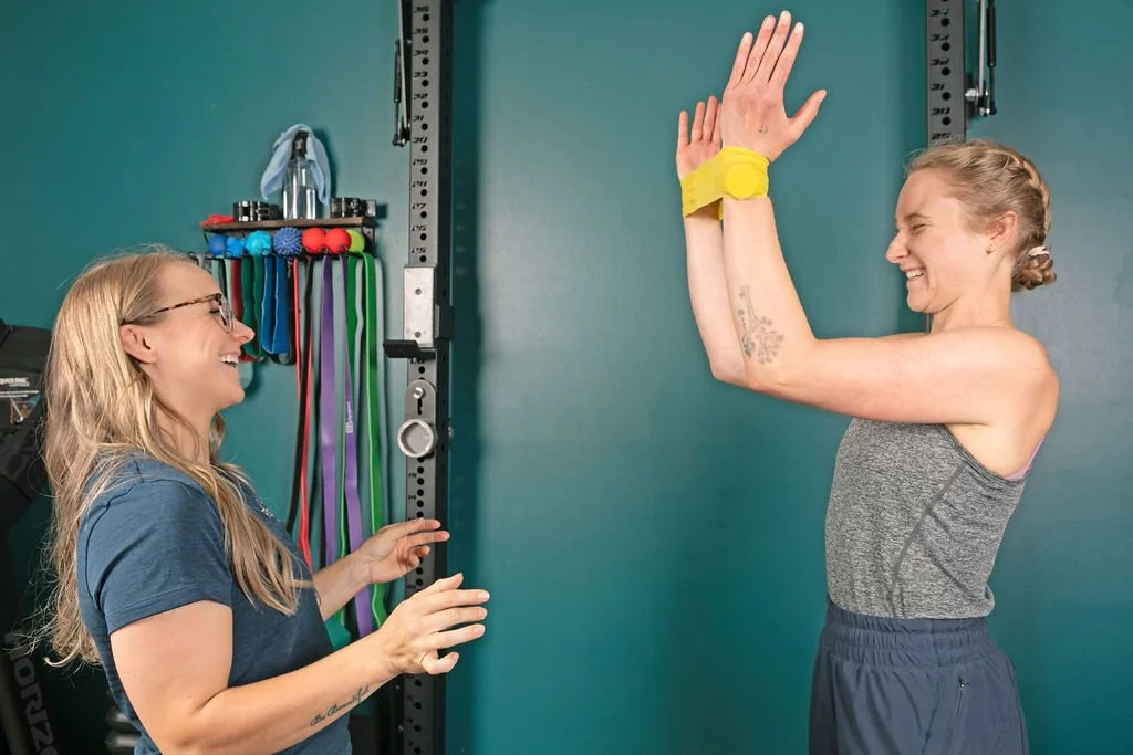 A Physio at Ridgeline Physio in Fernie BC doing rehab with a client for a shoulder injury