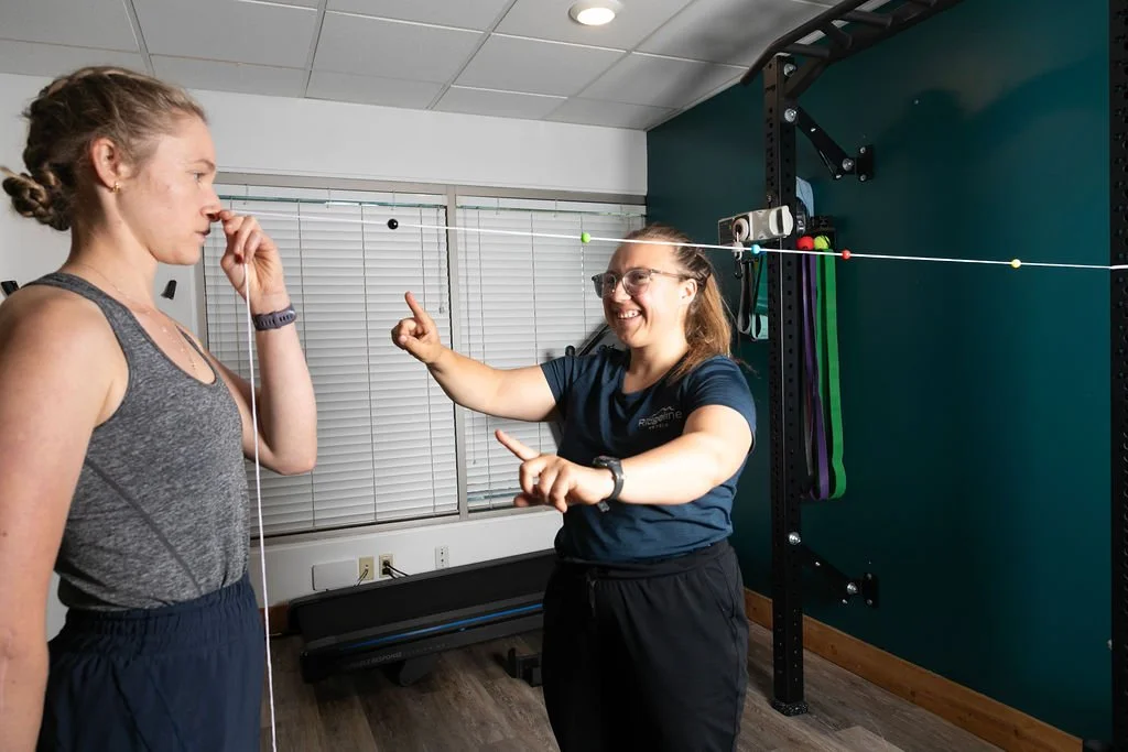 A concussion Physio at Ridgeline Physio performs visual rehabilitation with a client
