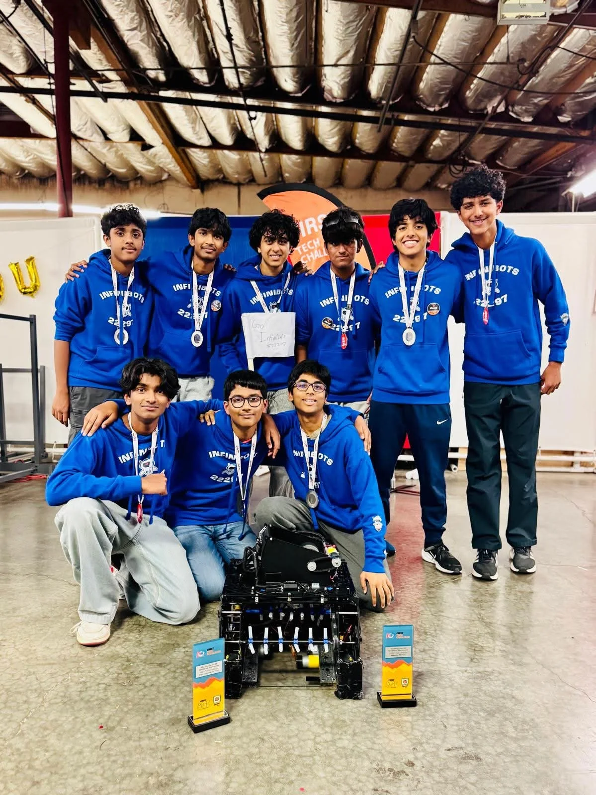 InfiniBots students together at a robotics competition