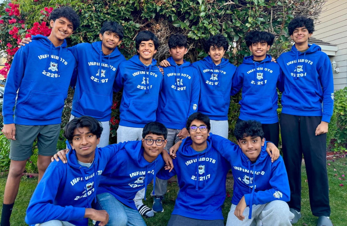 InfiniBots team members in blue team hoodies
