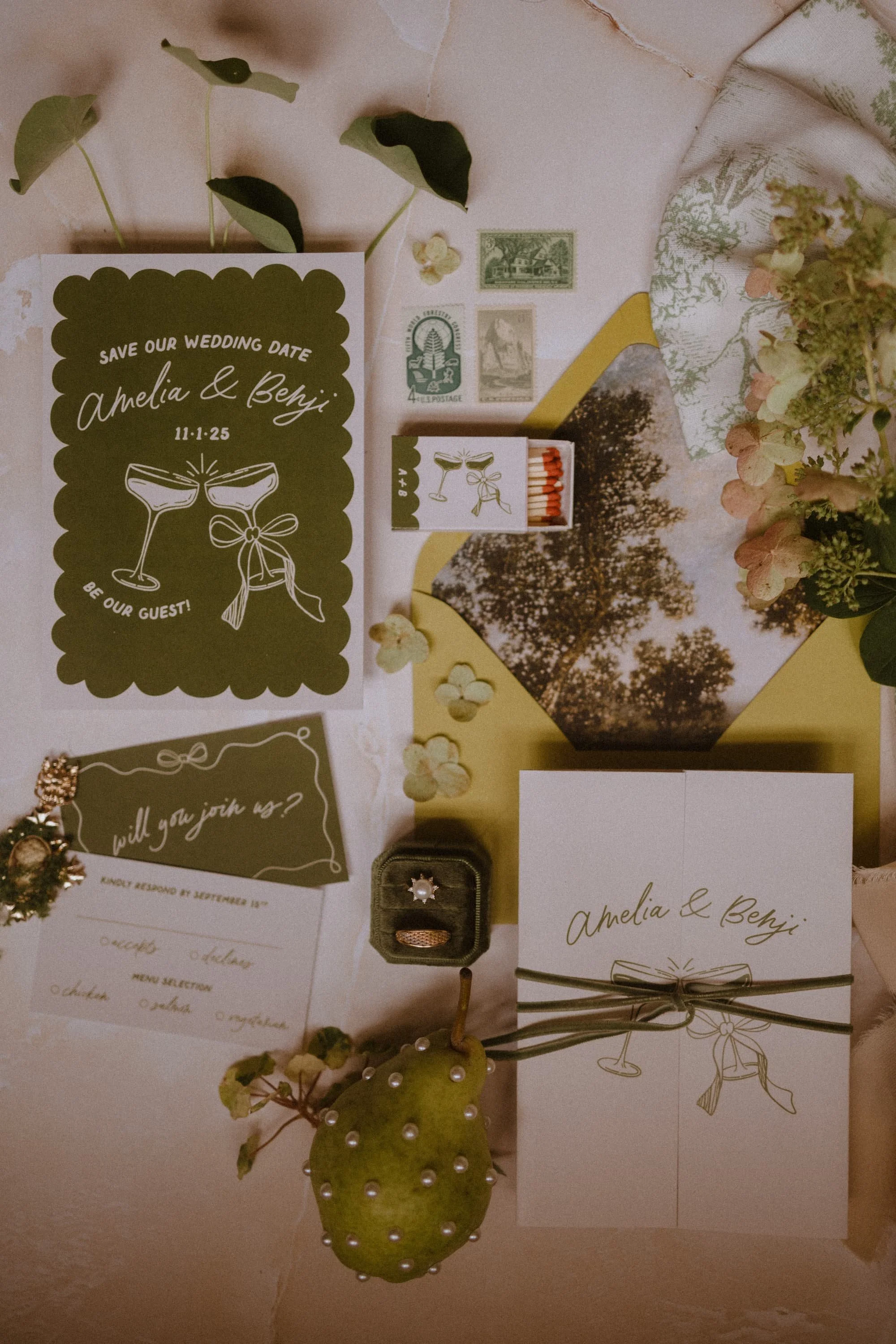 A flatlay including an invitation suite designed by Love, The Underwoods and other detail items.