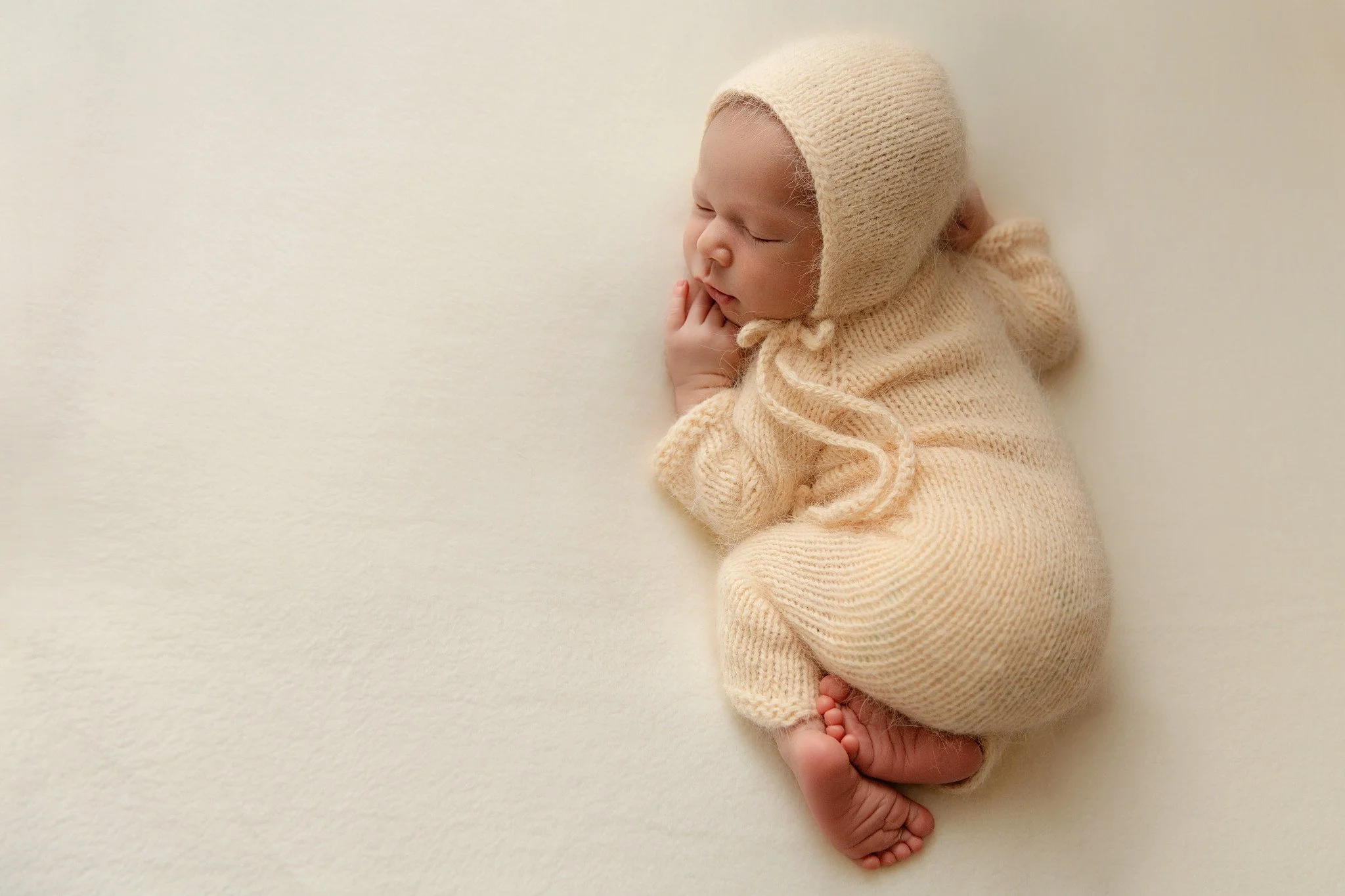 Alt text: Newborn baby lying on tummy during a studio photography session at Blink of Light Photography in Rouse Hill, Hills District Sydney