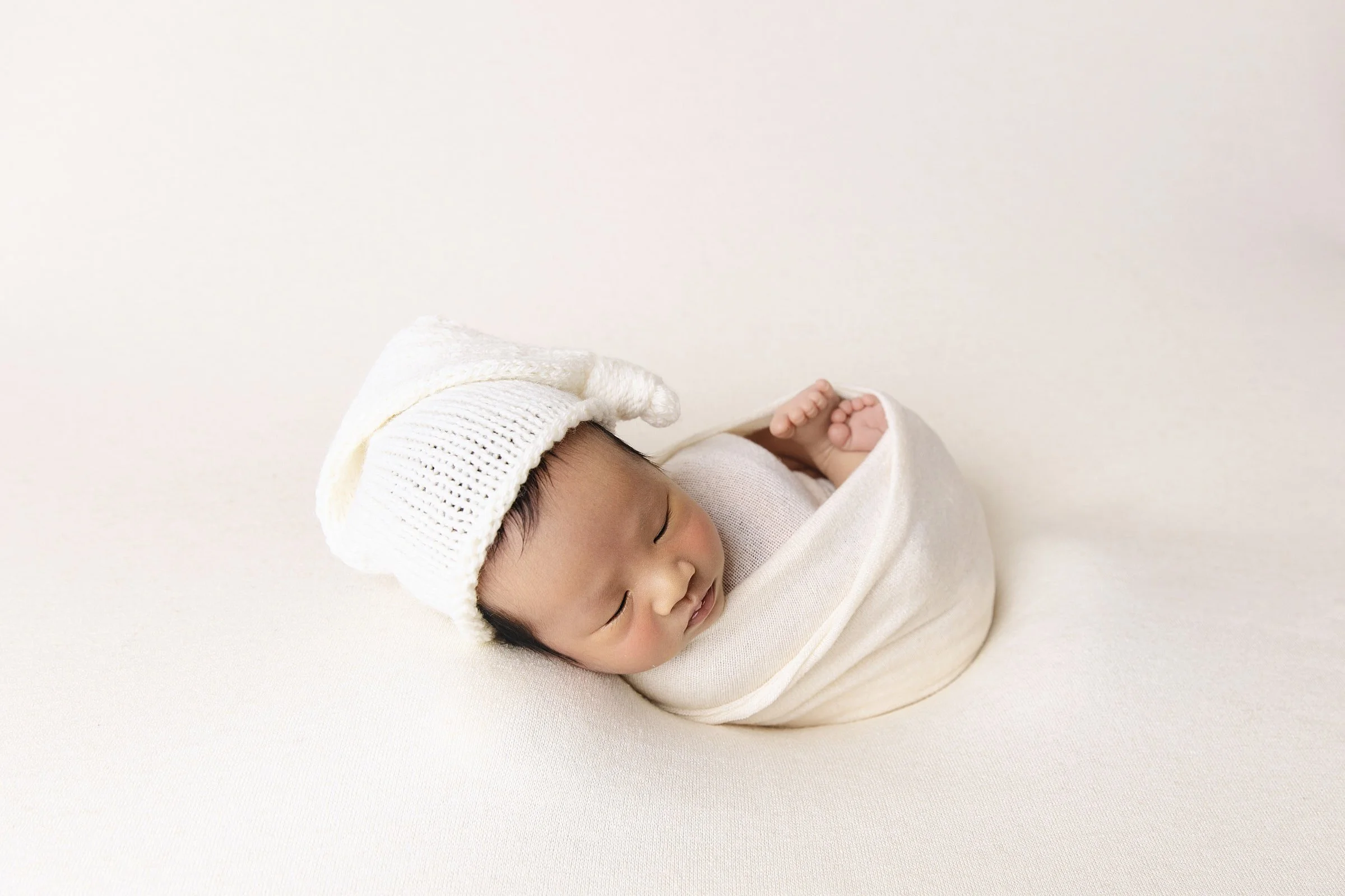 Sleeping newborn baby boy in neutral wrap, Rouse Hill studio