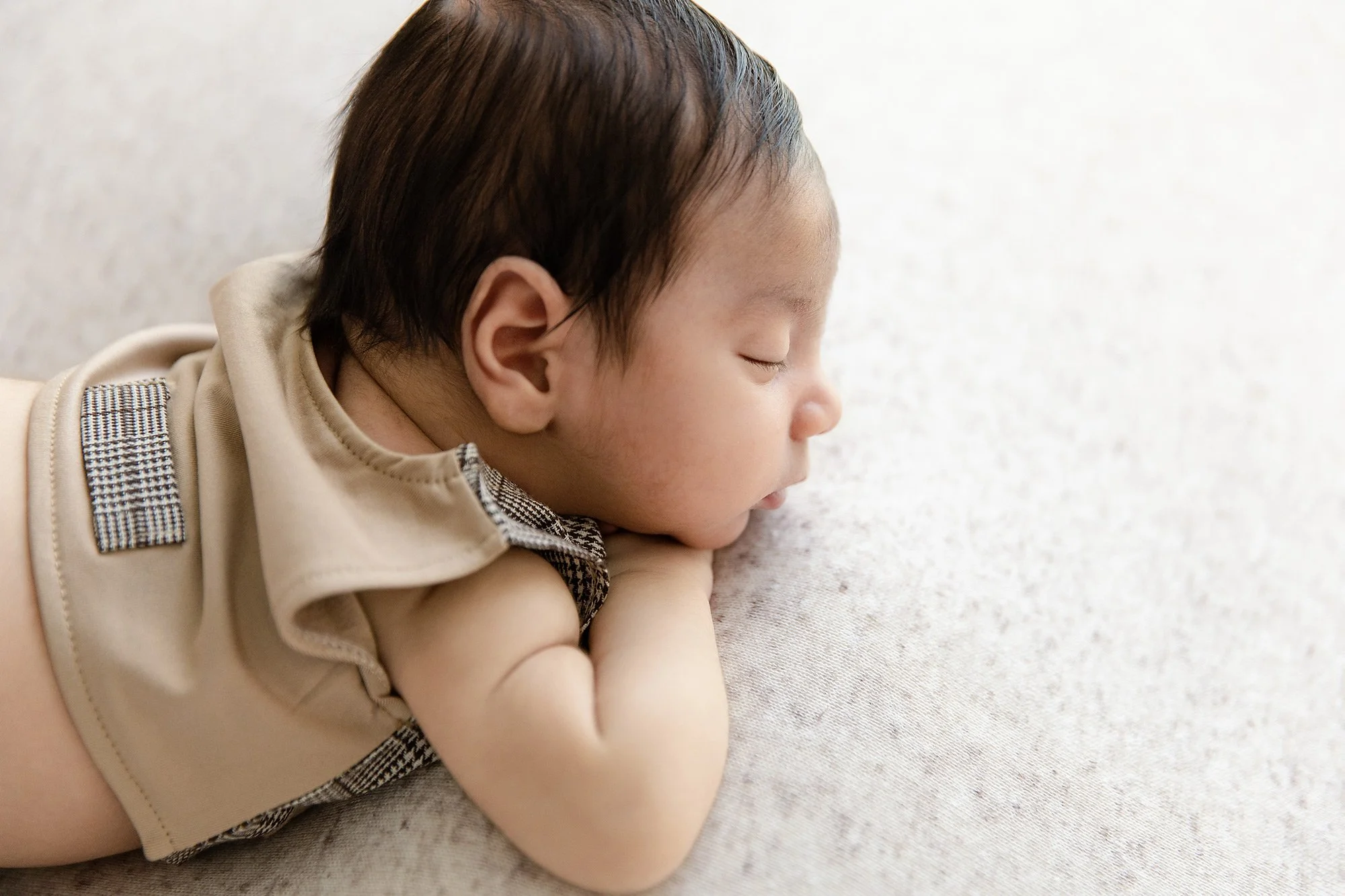 profile-shot-of-newborn-baby-boy-vhin-on-hands-classic-pose-during-Sydney-studio-session-1C3A9640-copy.jpg