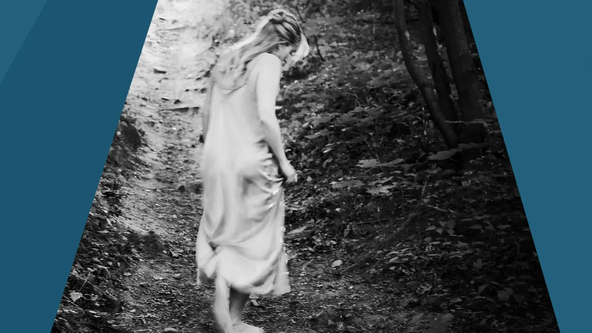 A black and white photo of a person with long blonde hair wearing a long dress. They are wallking away from the camera, along a dirt road. Graphic panels in shades of blue frame the image.
