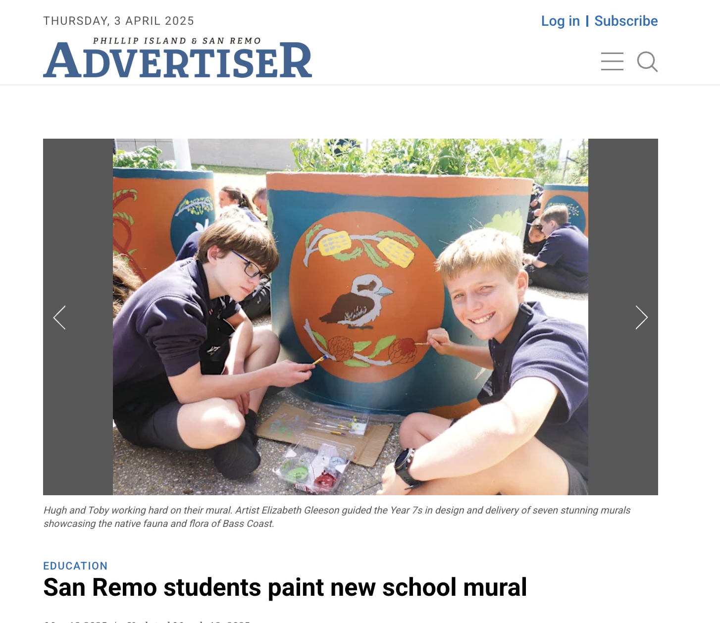 Two students, Hugh and Toby, painting a mural on a large outdoor cylindrical surface, depicting native fauna and flora of Bass Coast, with other students in the background.
