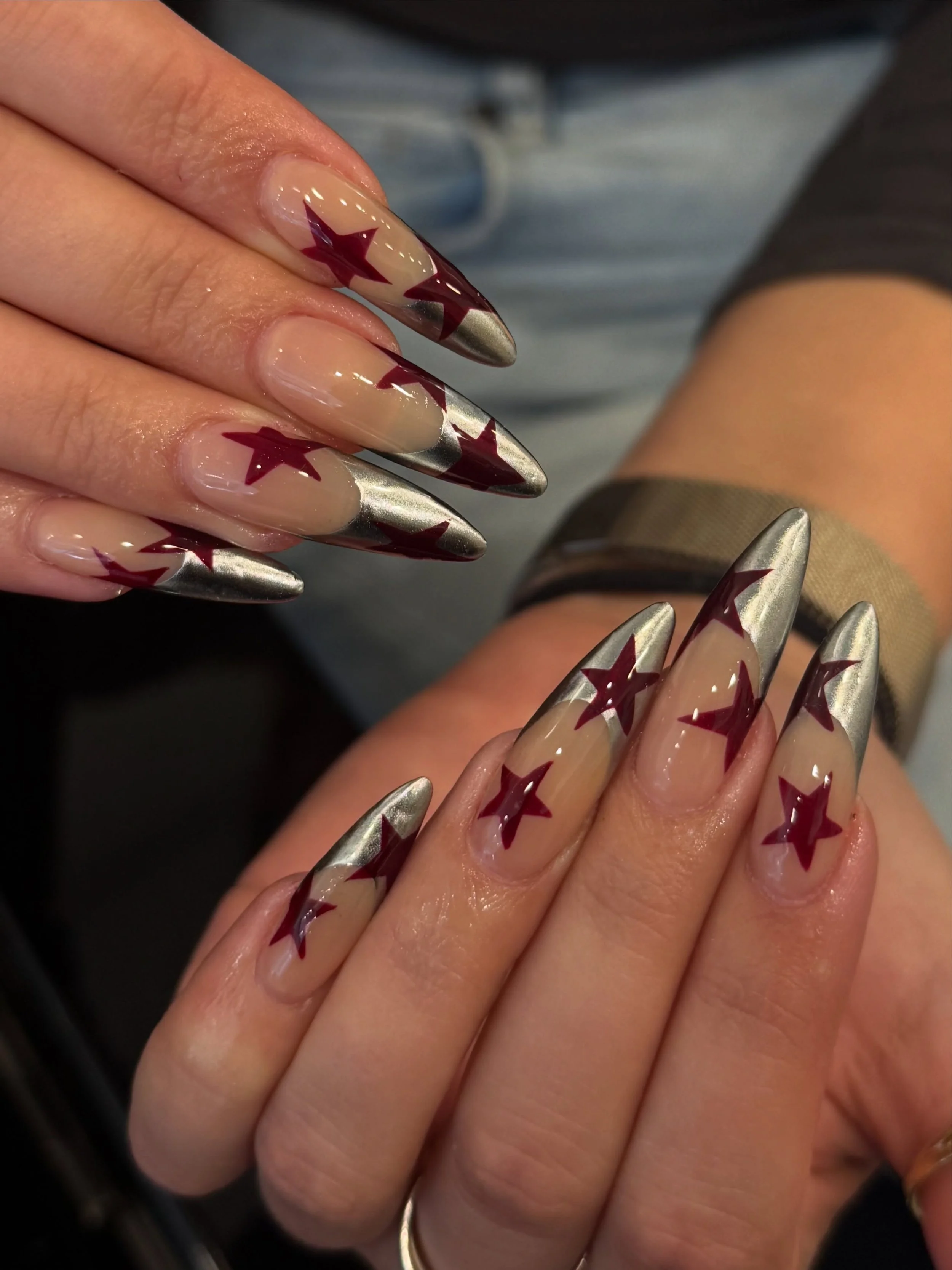 We&rsquo;ve been posting a lot of pink nail sets lately so today we&rsquo;re changing it up a little and sharing this stunning silver and red set! 🩶❤️

Nails by Master Artist, Amy. ⭐️

French tip nails. Star nails. Silver chrome nails. Silver nails.