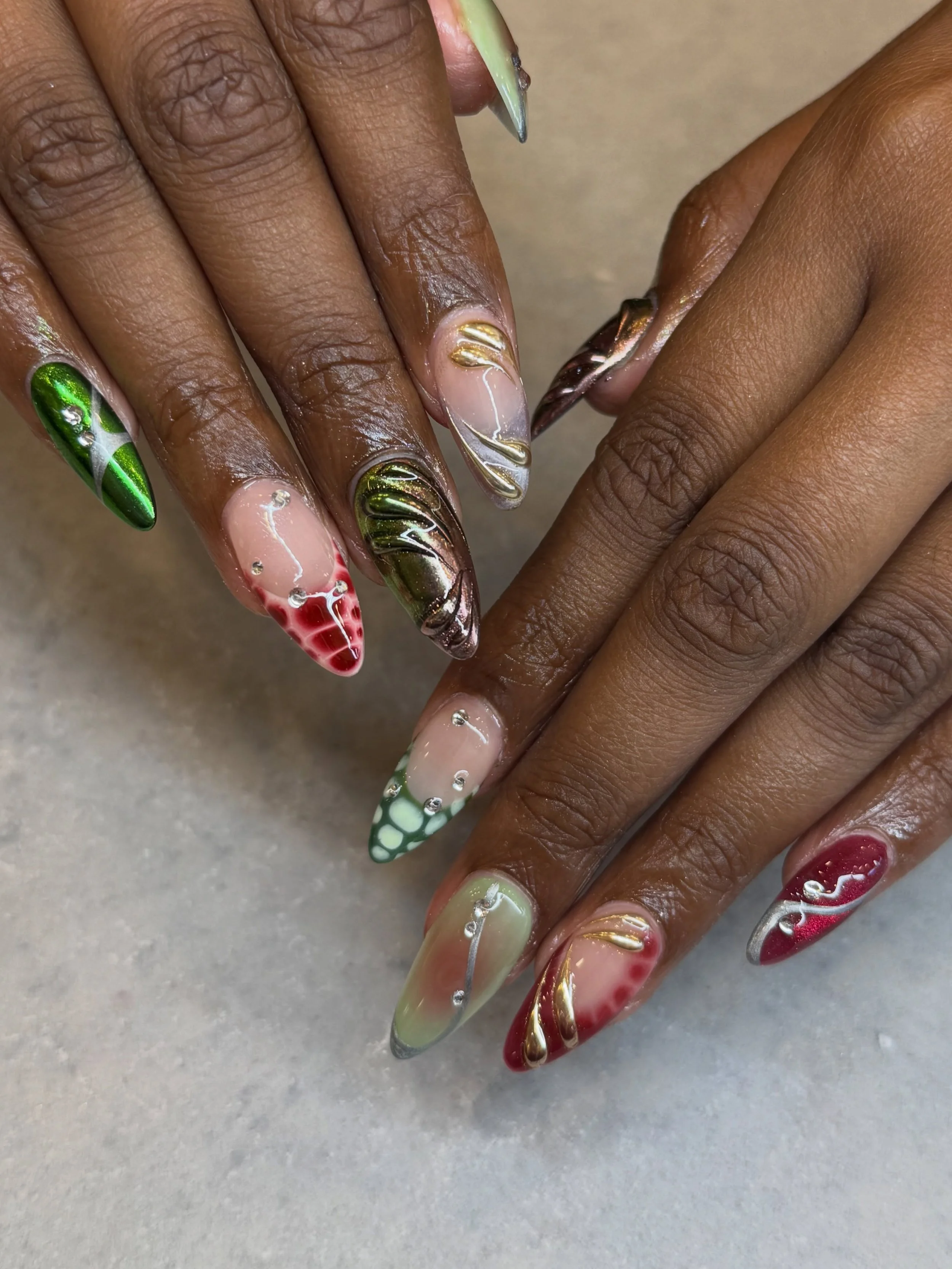 Green and red nails without making them look Christmas themed? Please, allow us to have the pleasure to. 😌

Nails by Master Artist, Amy. ❤️💚

Gel nail art. Sydney nail salon. Almond shaped nails. Gel X nails. Chrome nails. Y2K nails. 3D nail art. 3