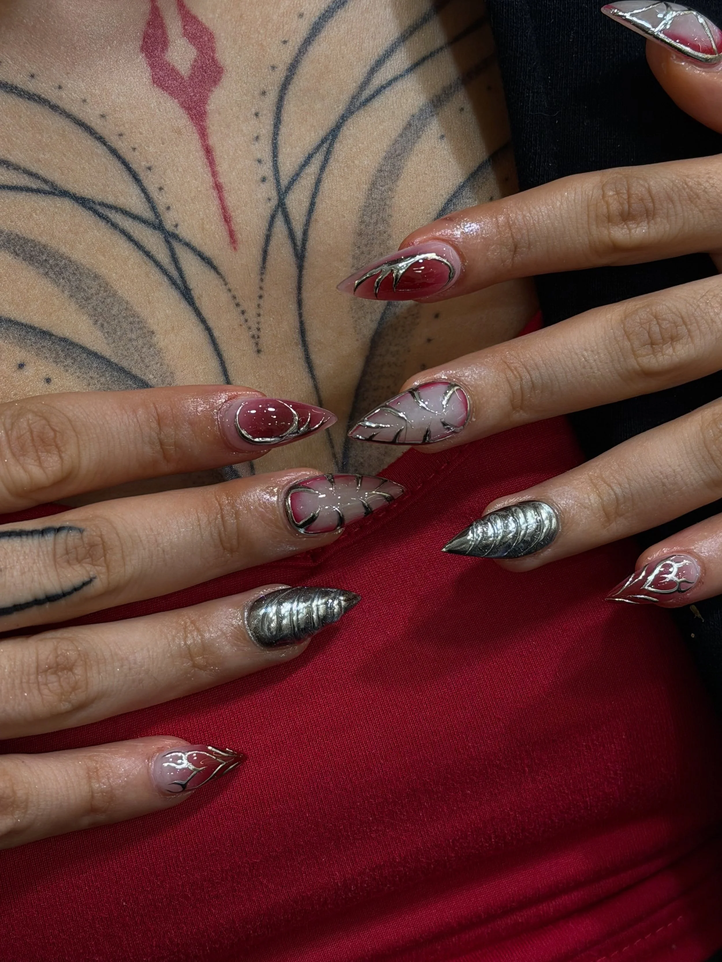 Stiletto shaped nails with red and chrome. 😍

Cyber nails looking sexy! ❤️

Nails by Master Artist, Amy. ⛓️

#cybernails #y2knails #chromenails #rednails #stilettonails stiletto nails, Y2K nails, chrome nails, red nails, sharp nails, nail extensions