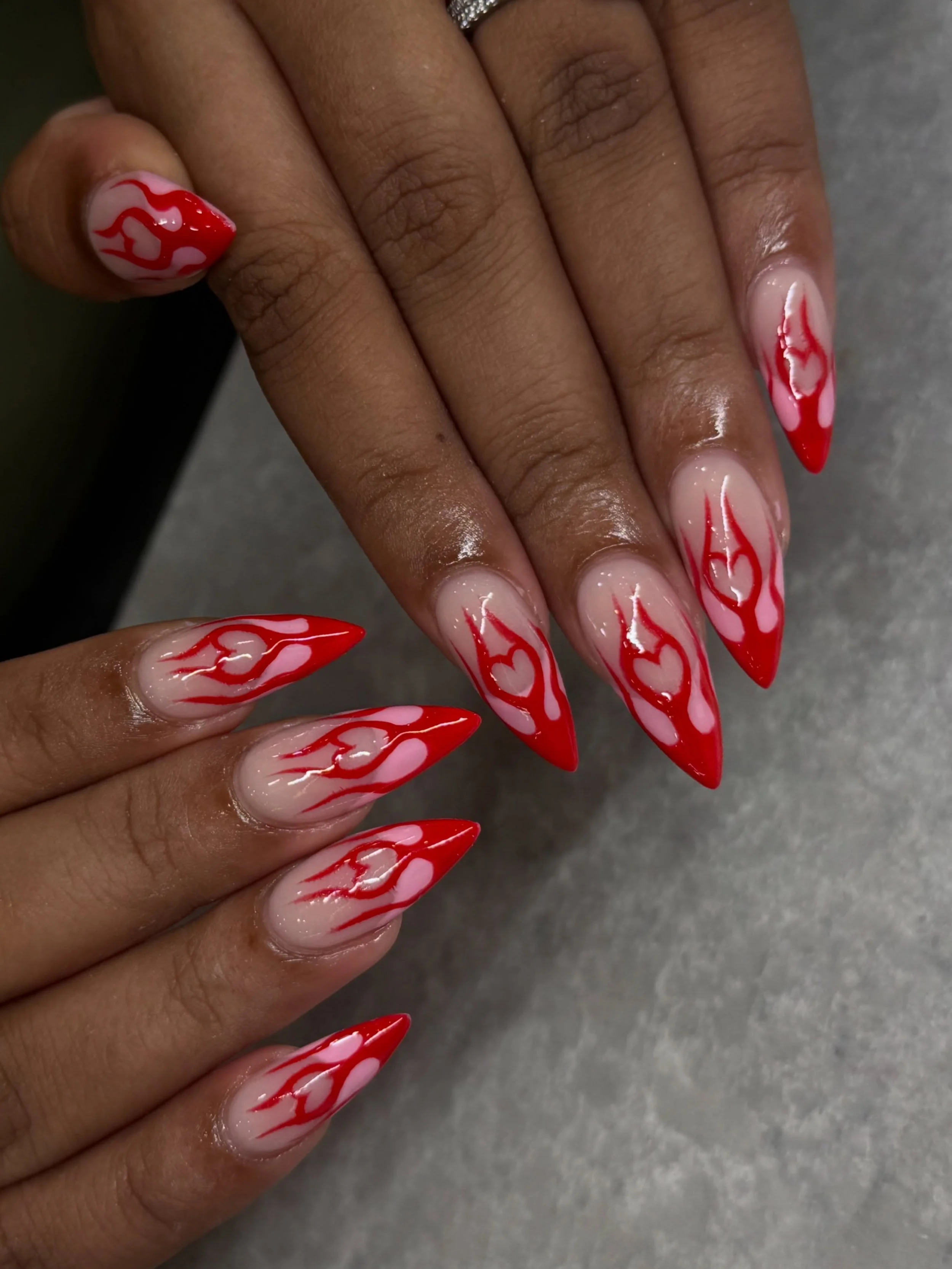 Flaming red hearts on stiletto nails. ❤️&zwj;🔥

Nails by Master Artist, Amy. 🔺

#stilettonails #rednails #frenchtipnails #heartnails #gelnailart stiletto shaped nails, red nails, French tip nails, heart nails, nail art, gel nails, biab manicure, ac