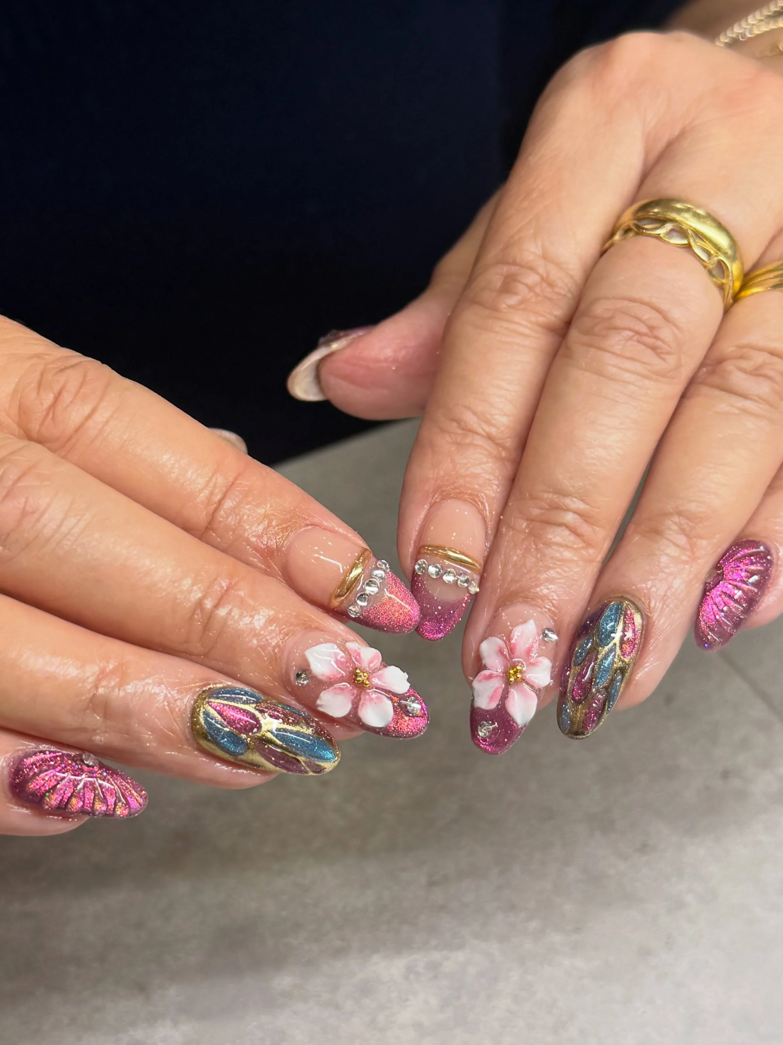 Pink cat eye nails but even beautiful-er with chrome and 3D flowers and bangles. 💗

Nails by Master Artist, Amy. ✨

Amy is incredible in her craft for nails. If you&rsquo;d like to book her in, send us a message!

#cateyenails #chromenails #3dnails 